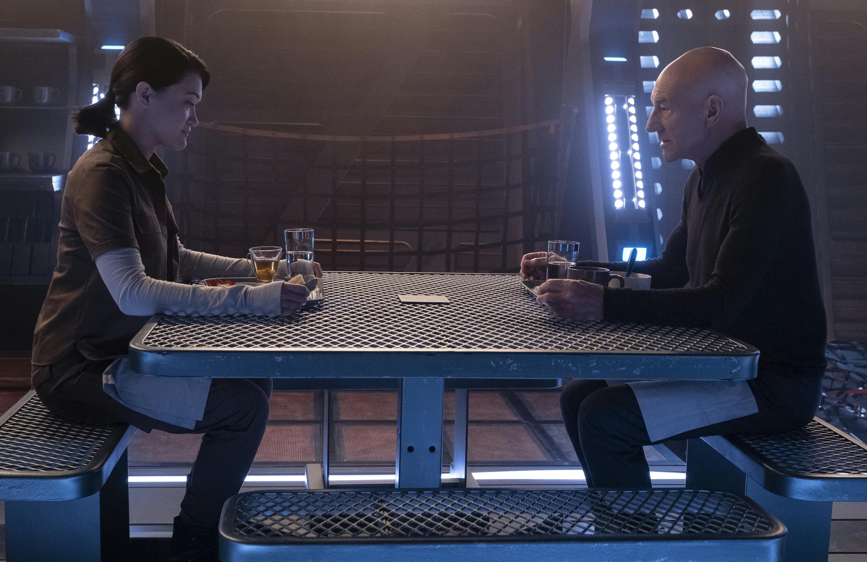 Soji and Picard sit across from each other looking down at their meal in the mess in 'Broken Pieces'