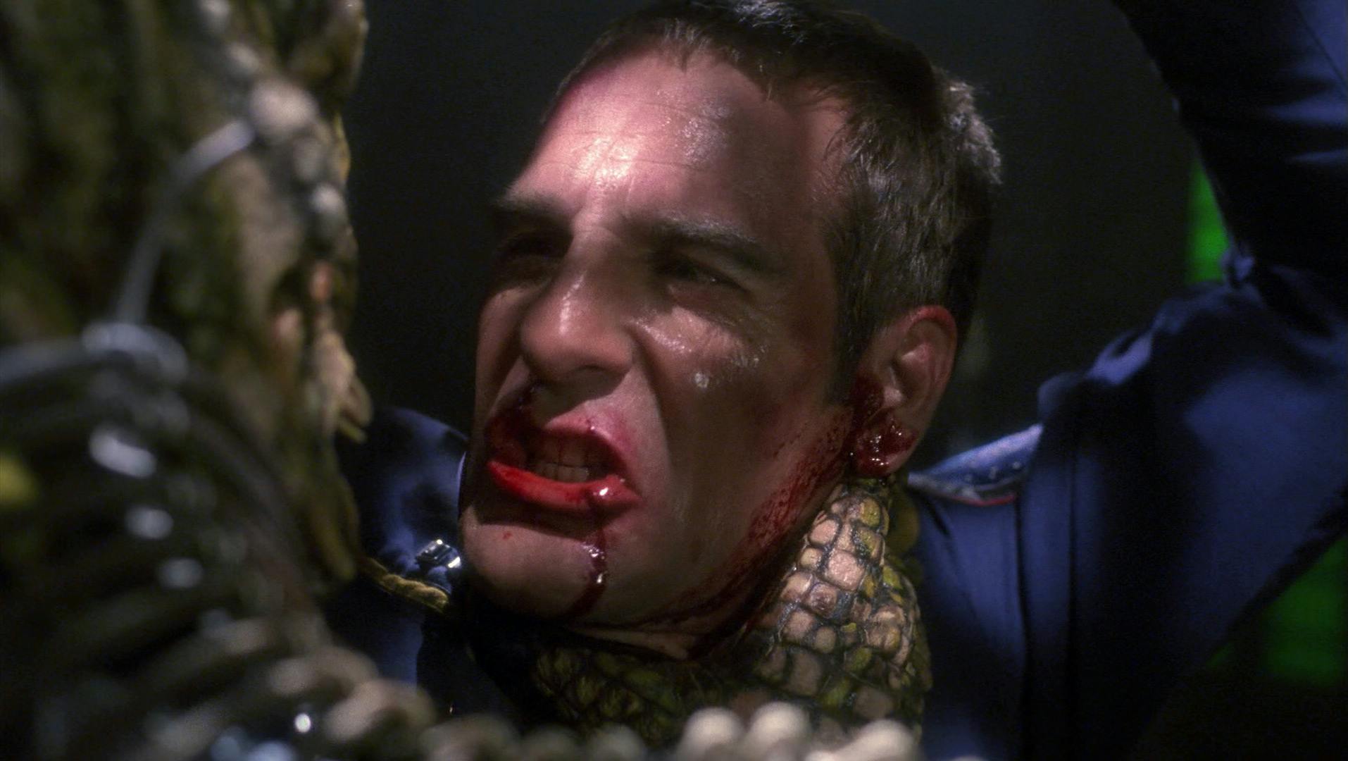 A beaten and bloody Archer argues with his Xindi captor in 'Azati Prime'
