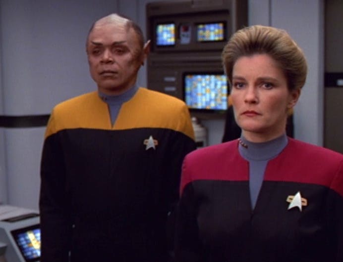 Janeway stands in front of and with her back to Tuvix as she weighs her decision in 'Tuvix'