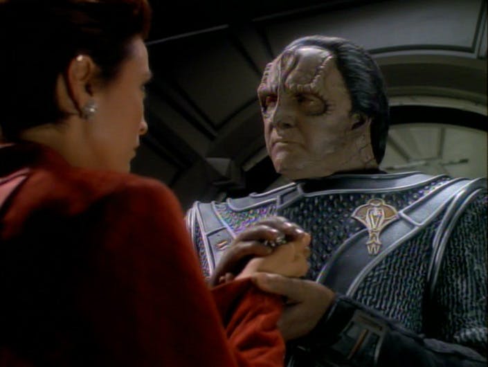 Aboard Deep Space 9, the Cardassian Tekeny Ghemor clasps Kira's hands in his entrusting her with the necklace he gave his long lost daughter viewing the Bajoran as the closest family he has left in 'Second Skin'