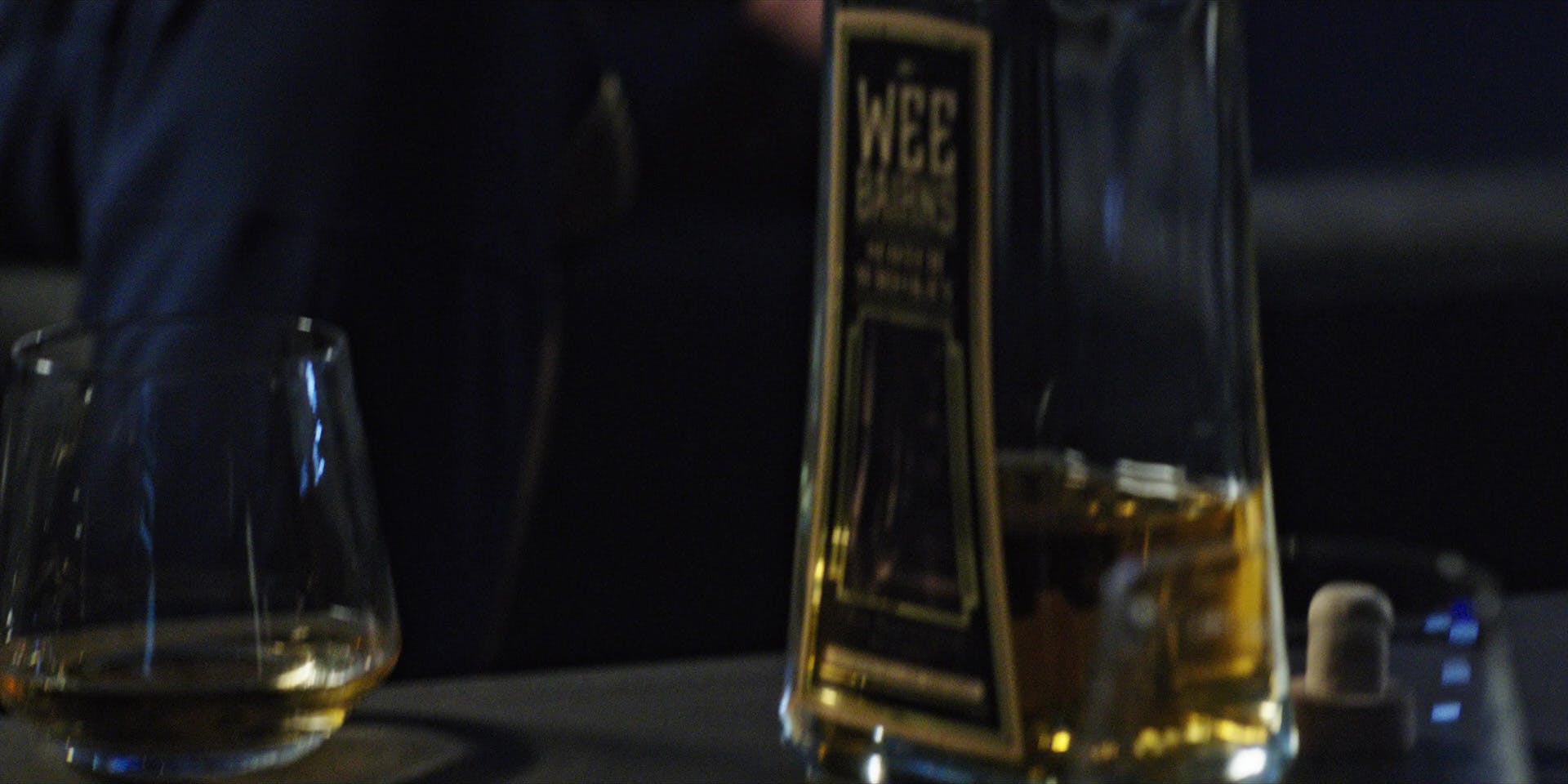 Close-up of Captain Gabriel Lorca's bottle of Wee Bairns and a cocktail glass in his quarters in 'Lethe'