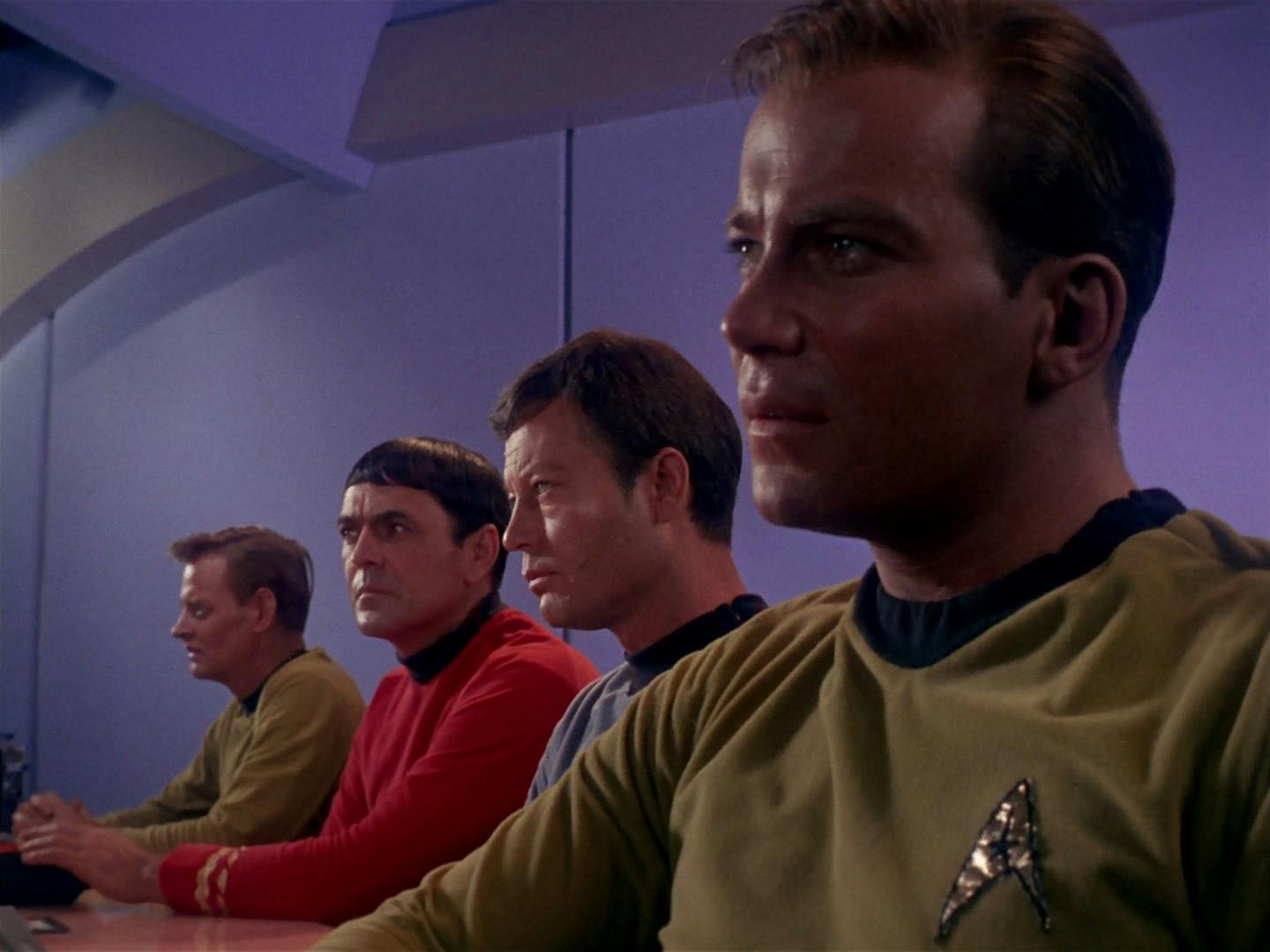 Aboard the Enterprise, Scotty, Bones, and Kirk listen to Harry and his captive cargo's testimony during the con man's hearing in 'Mudd's Women'
