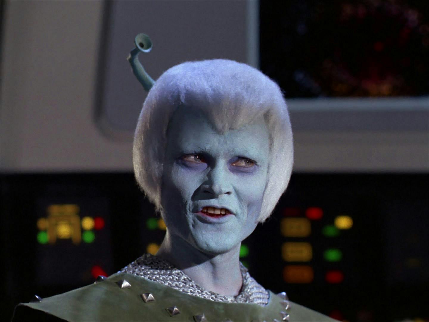 Thelev, an Orion posing as an Andorian, in order to infiltrate the Babel conference is exposed after the murder of a Tellarite ambassador and damage to his faux antennae, stands aboard the Enterprise bridge witnesses his ship on the viewfinder in 'Journey to Babel'
