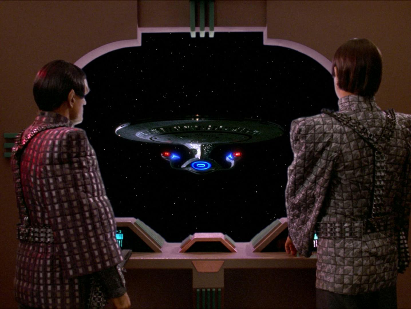 Subcommander N'Vek and Deanna Troi posing as Major Rakal of the Tal Shiar look out the viewfinder of the Romulan warbird Kazara to face the Enterprise-D in 'Face of the Enemy'