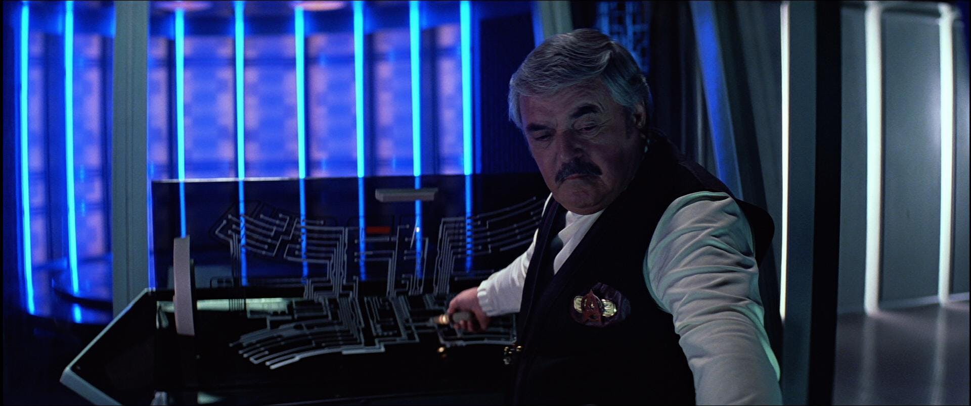 Montgomery Scott tinkers with the console in Star Trek V: The Final Frontier
