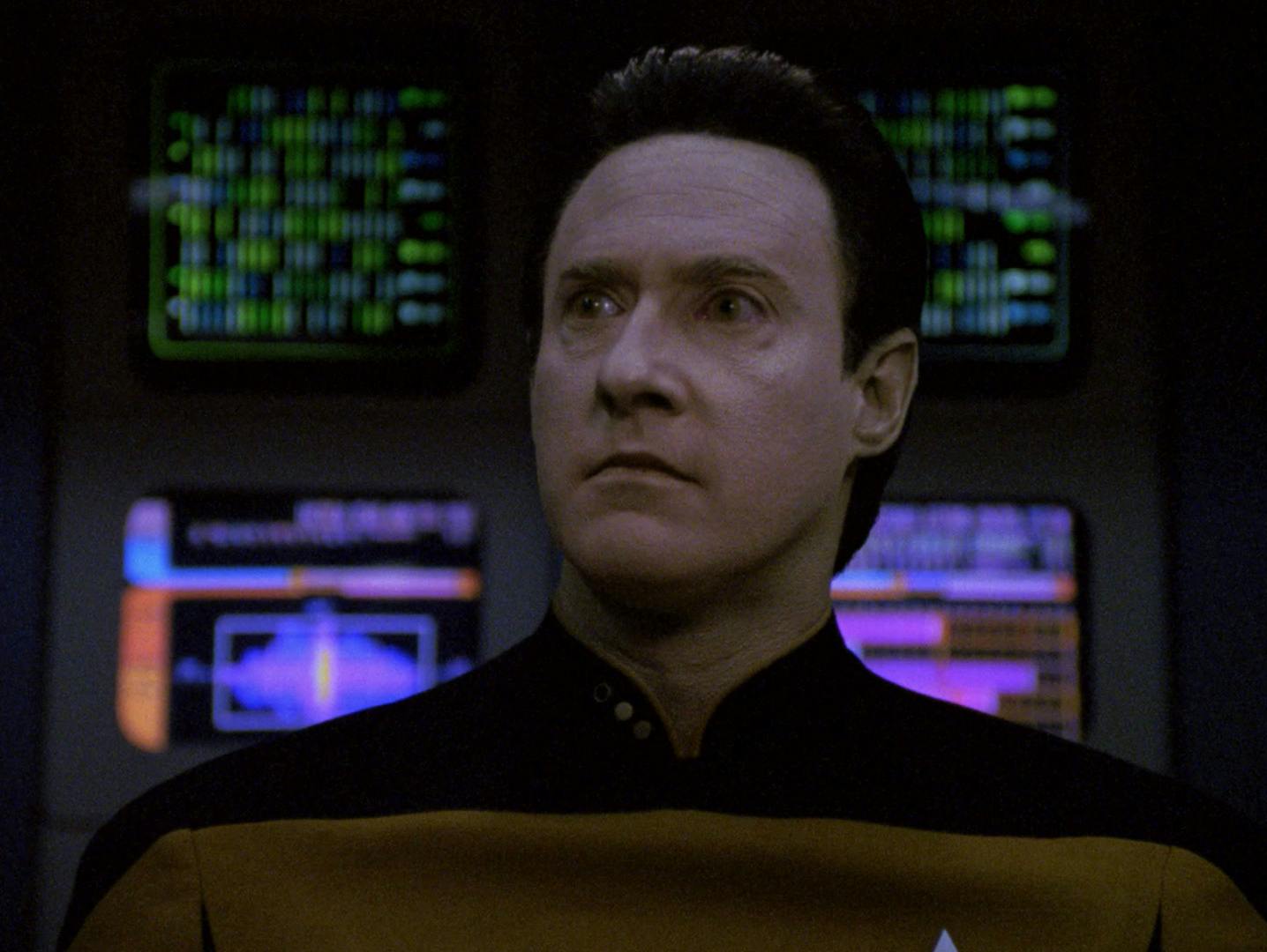 In front of a wall of LCARS and monitors, Data confidently stares down Lt. Commander Hobson in 'Redemption II'
