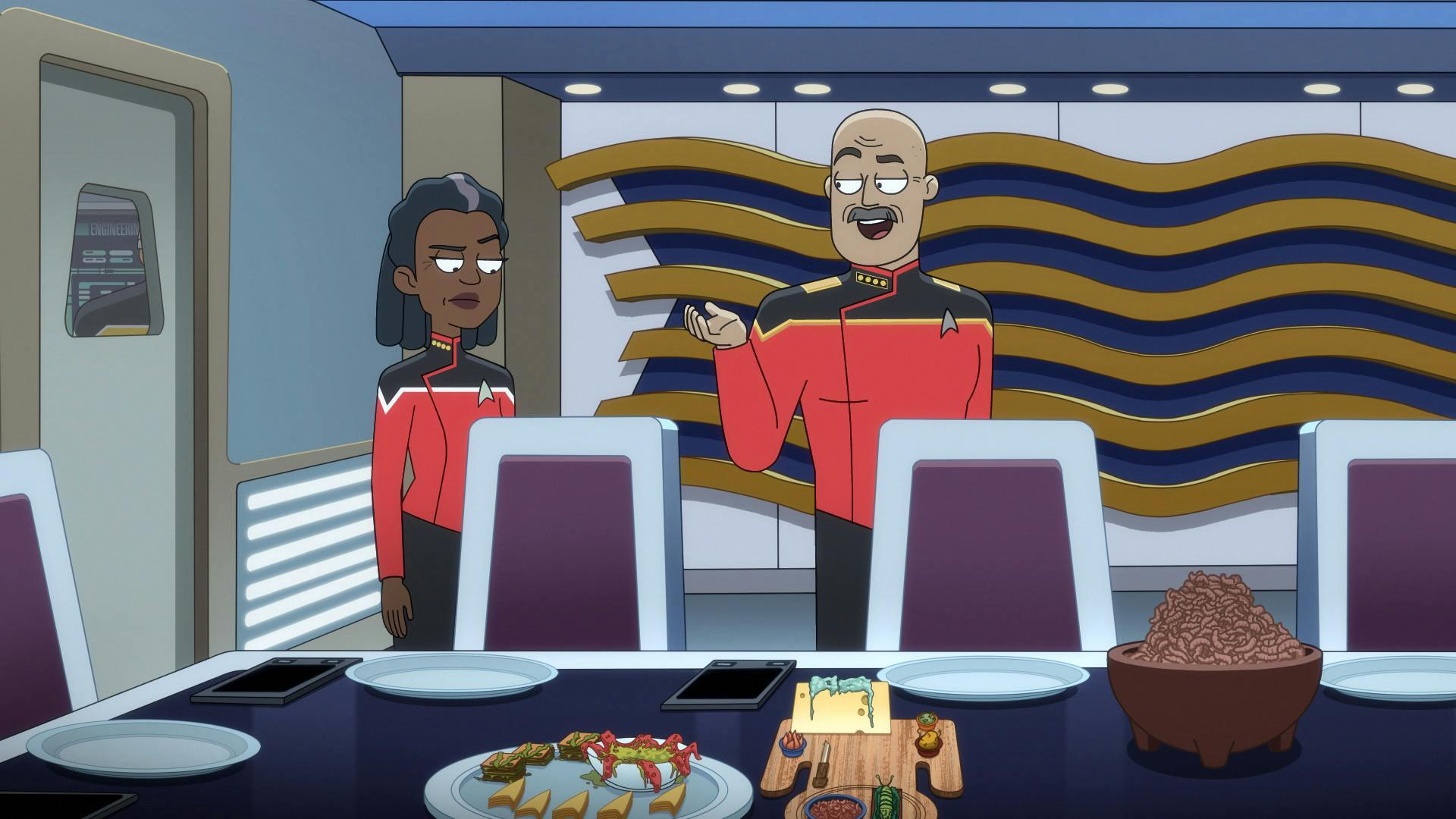 Aboard the U.S.S. Toronto, Admiral Vassery leads Captain Freeman in their conference room where the table is full of Ferengi snacks in 'Parth Ferengi's Heart Place'