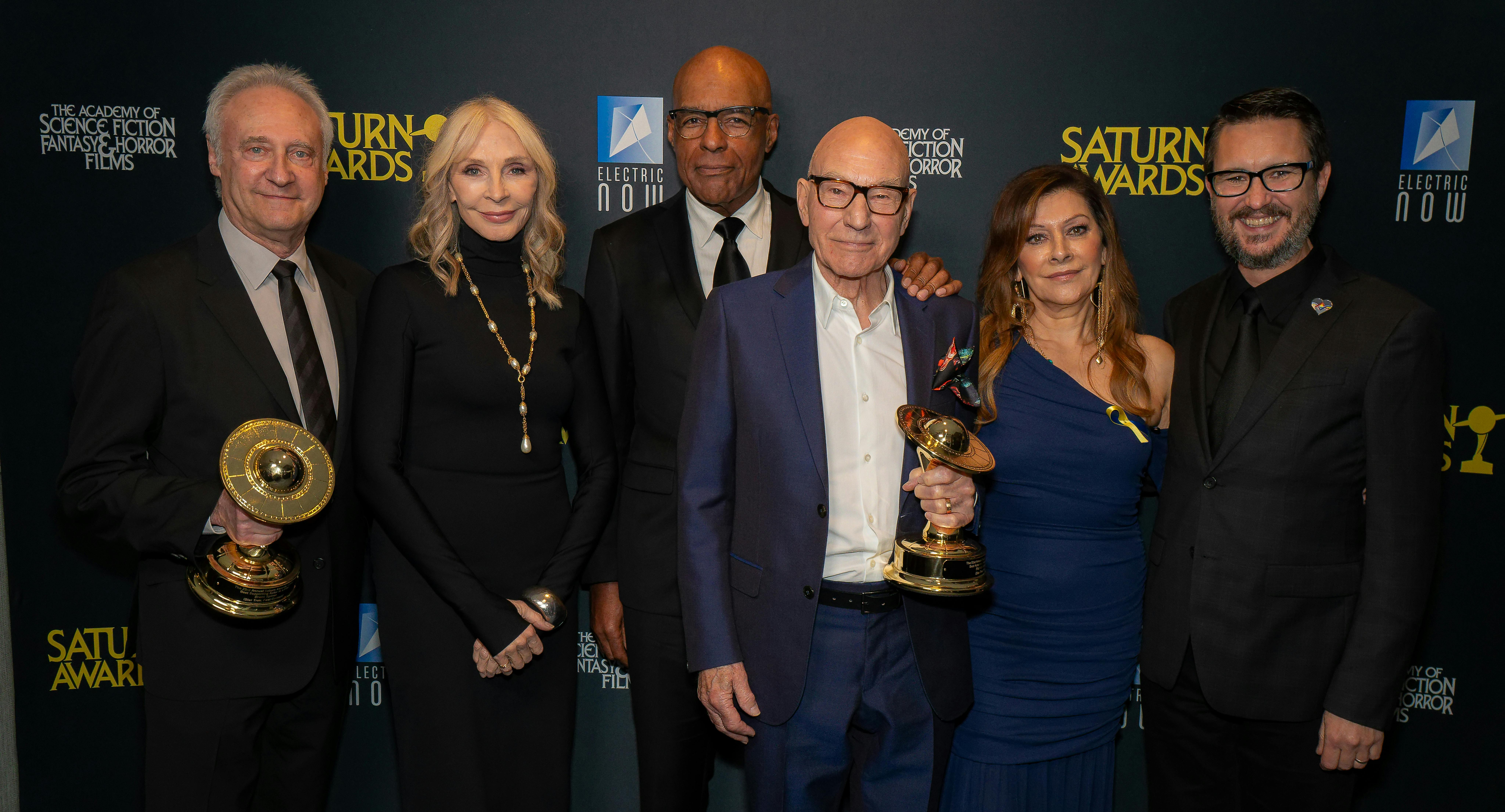 Brent Spiner, Gates McFadden, Michael Dorn, Patrick Stewart, Marina Sirtis, and Wil Wheaton backstage at the Saturn Awards with their awards