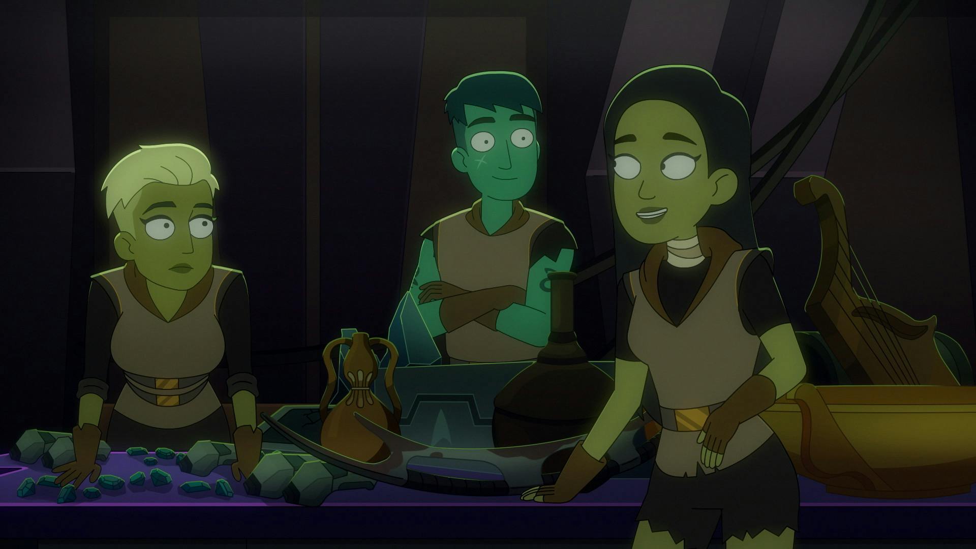 Three Orion lower deckers stand at a table surrounded by rocks, weapons, and other junk on their ship in 'Something Borrowed, Something Green'