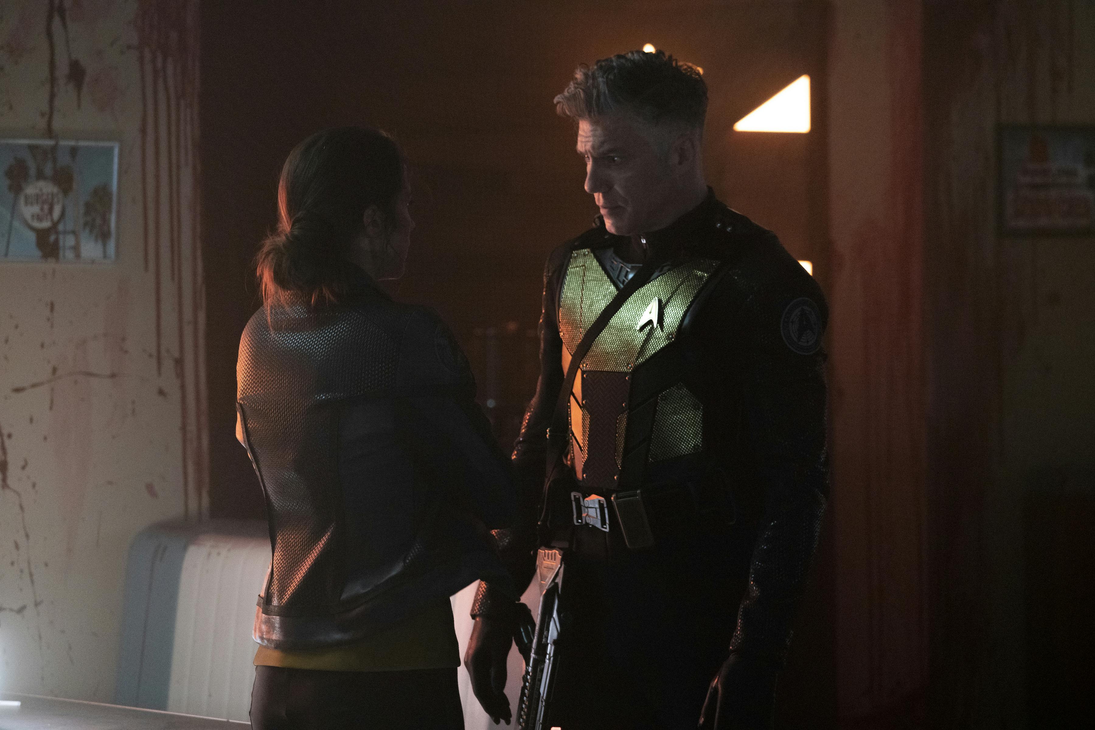Captain Pike, in tactical field gear, reunites with Marie Batel on the surface of Parnassus Beta in 'Hegemony'