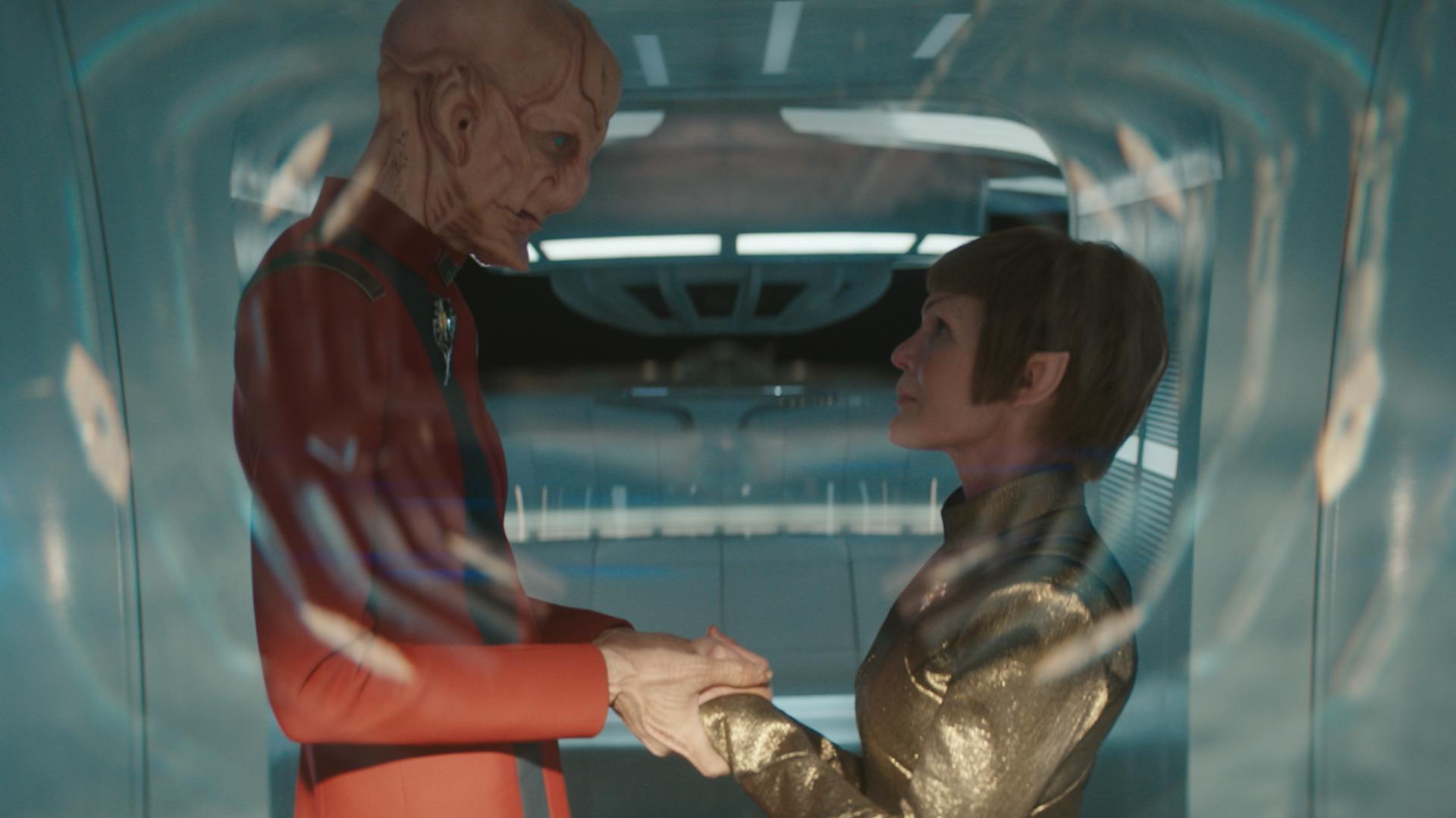 At Starfleet Headquarters, Saru and T'Rina clasp hands as they gaze in each other's eyes in 'Red Directive'