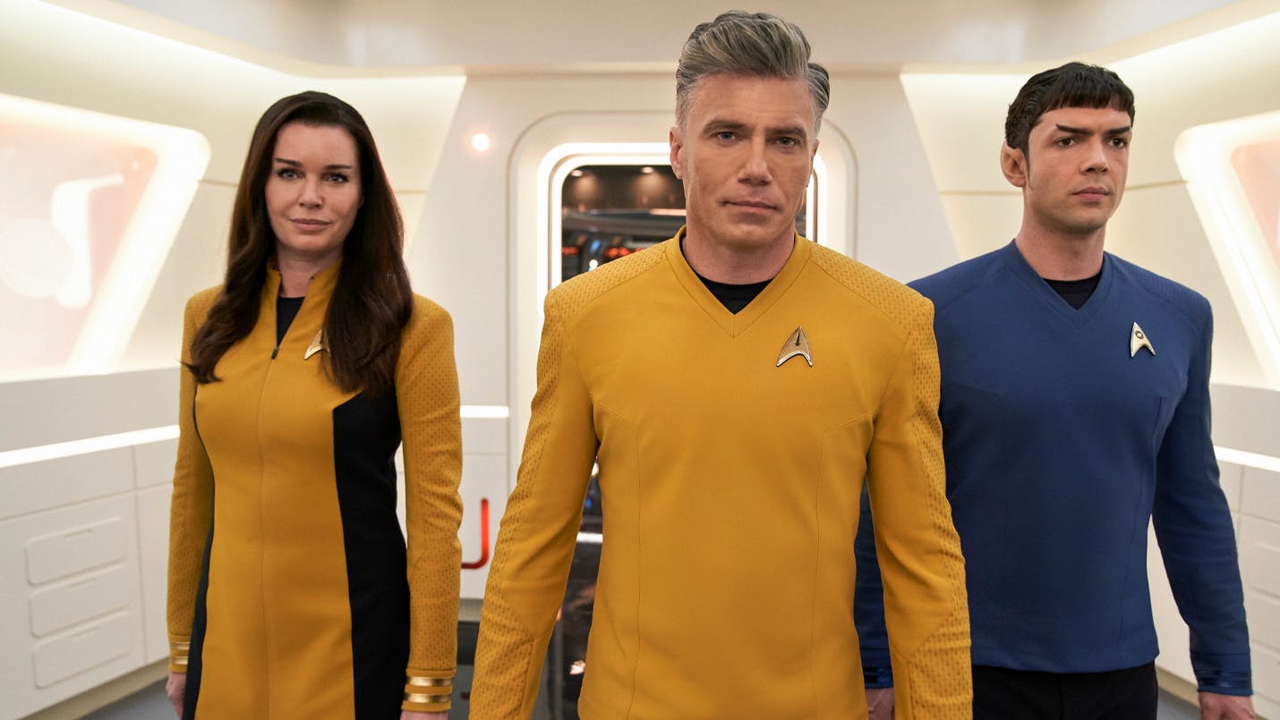 Christopher Pike, Una Chin-Riley (Number One), and Spock walk down a corridor of the U.S.S. Enterprise as seen in Star Trek: Strange New Worlds