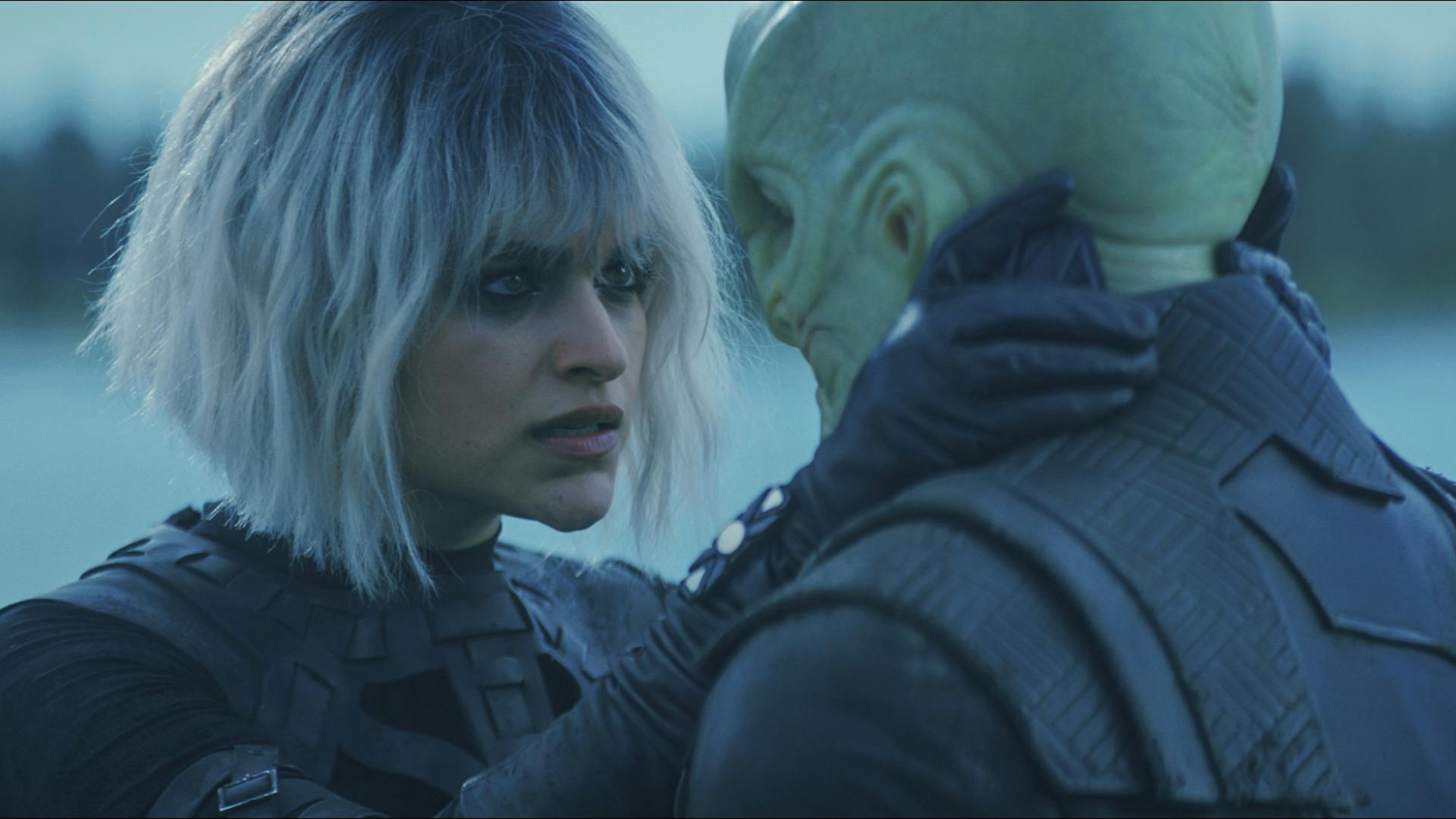 On the surface of Salata Major, Moll grips L'ak face as she reassures him in 'Face the Strange'
