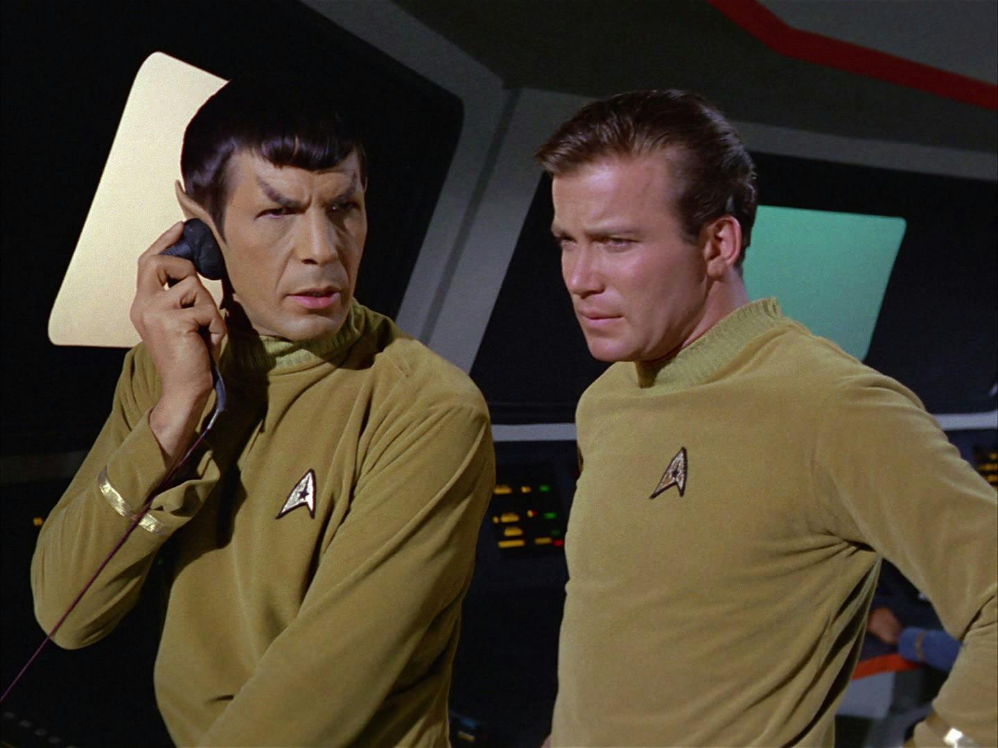 On the Bridge of the Enterprise, Spock holds a receiver to his ear as Kirk stands behind him in 'Where No Man Has Gone Before'