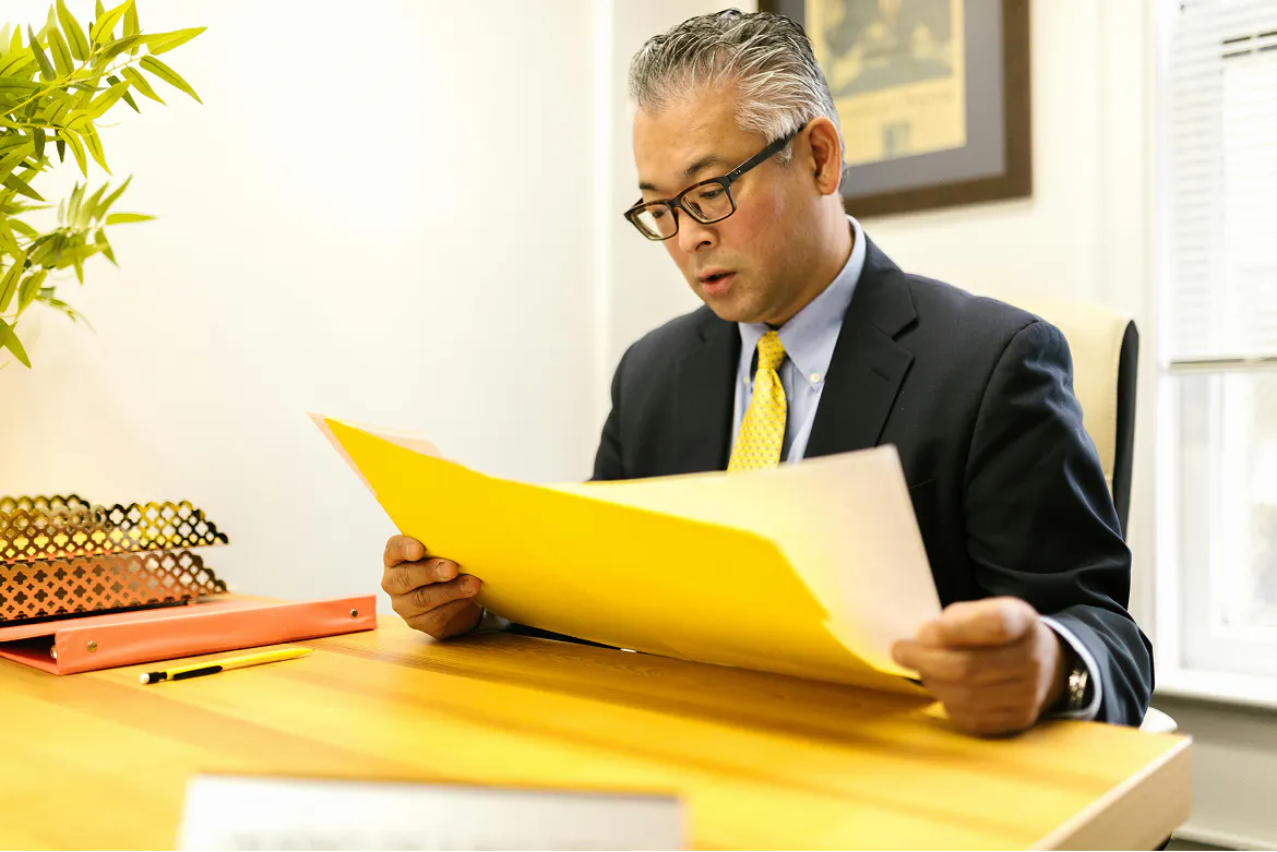 Man sitting in office looking at documents