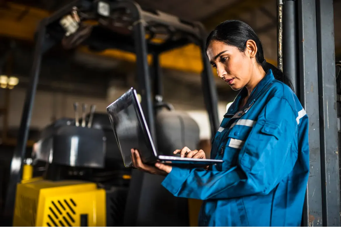 Female technician looking at data in a book