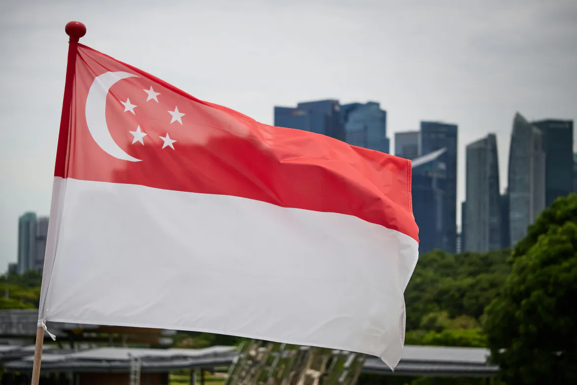 Singapore flag with the Singapore landscape in the background