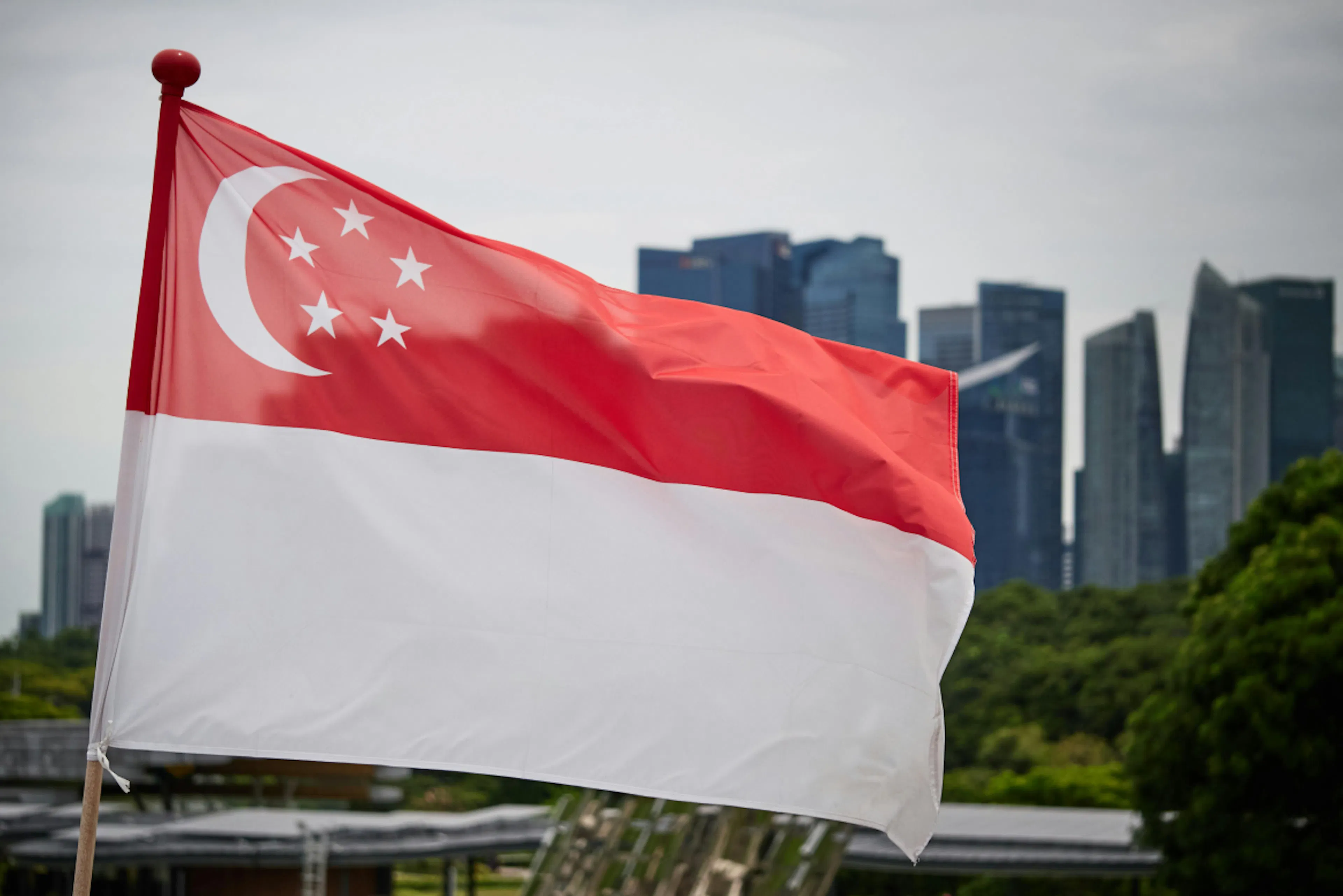 Singapore flag with the Singapore landscape in the background