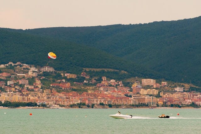 An image of a scenery in Bulgaria with a parachute in the sky