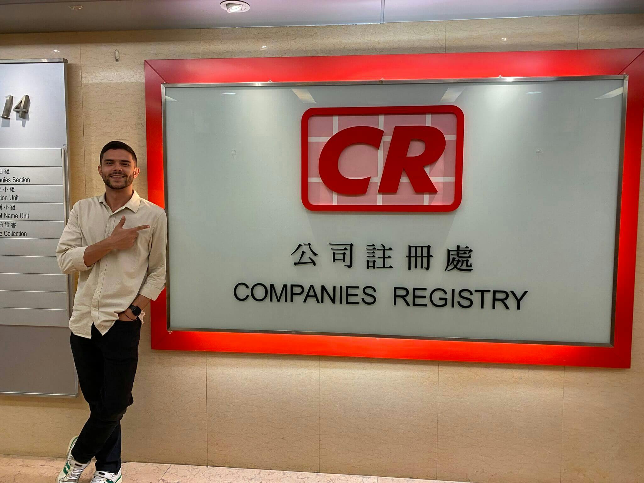 A photograph of Nestor Garcia, head of company creation services at Statrys, standing next to the companies registry office entrance in Hong Kong