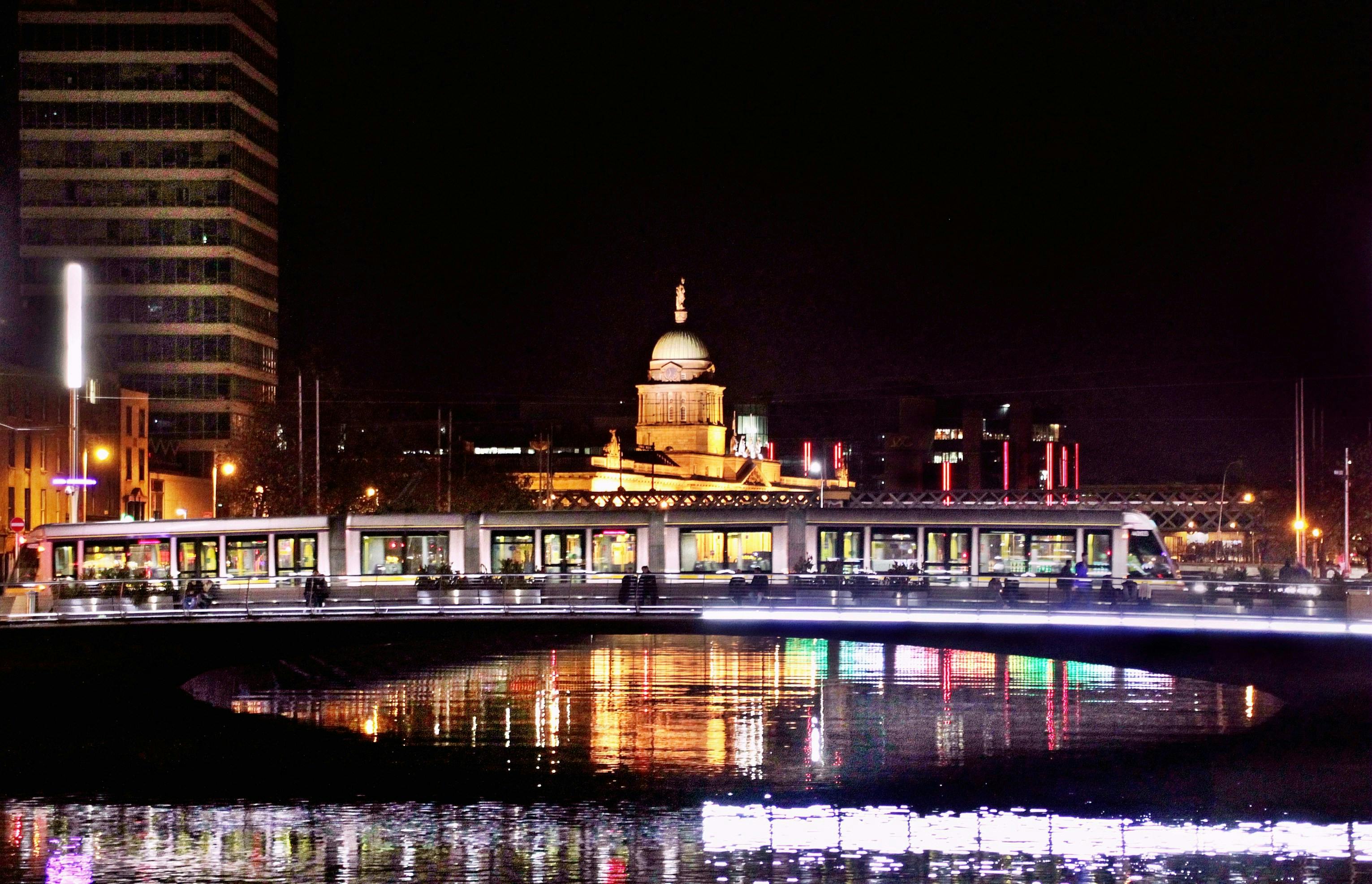 Reflection of buildings light on body of water at night in Dublin, Ireland