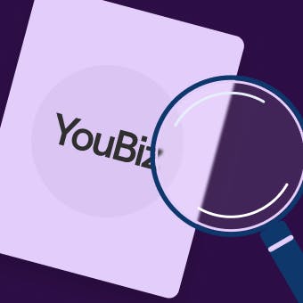 An image featuring a card with the word 'YouBiz' on it and a magnifying glass placed in front of the card