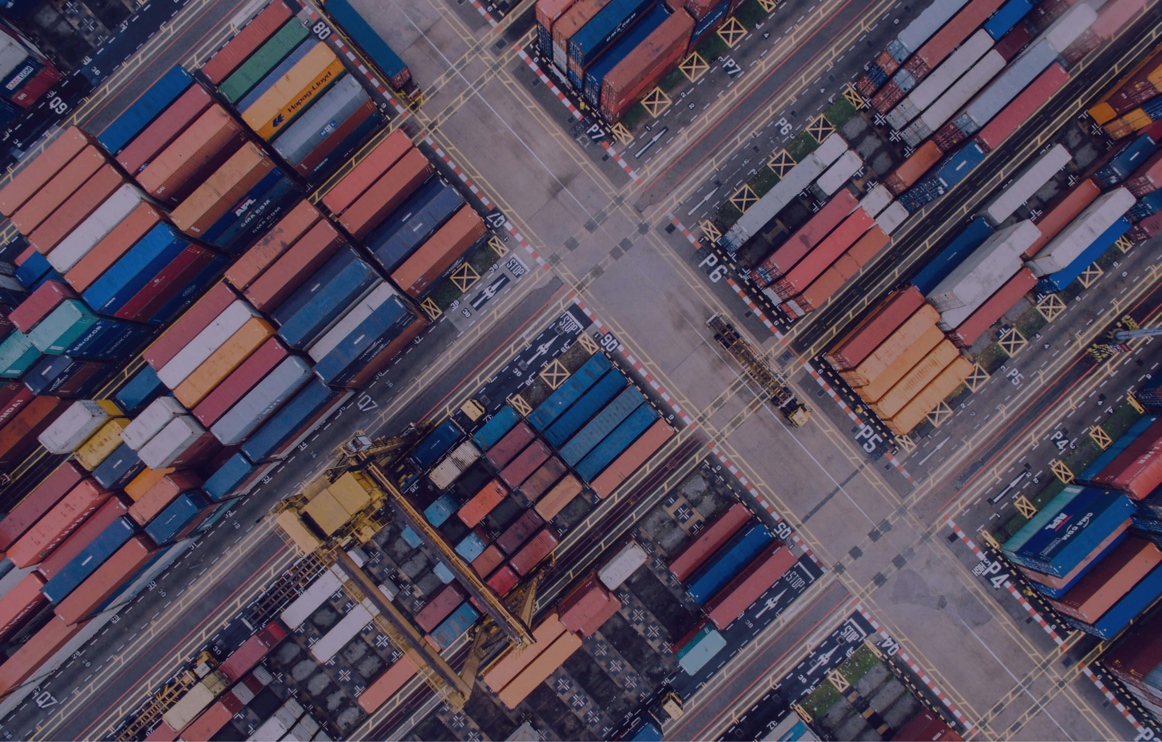 An aerial shot of a shipping dock with shipping containers.