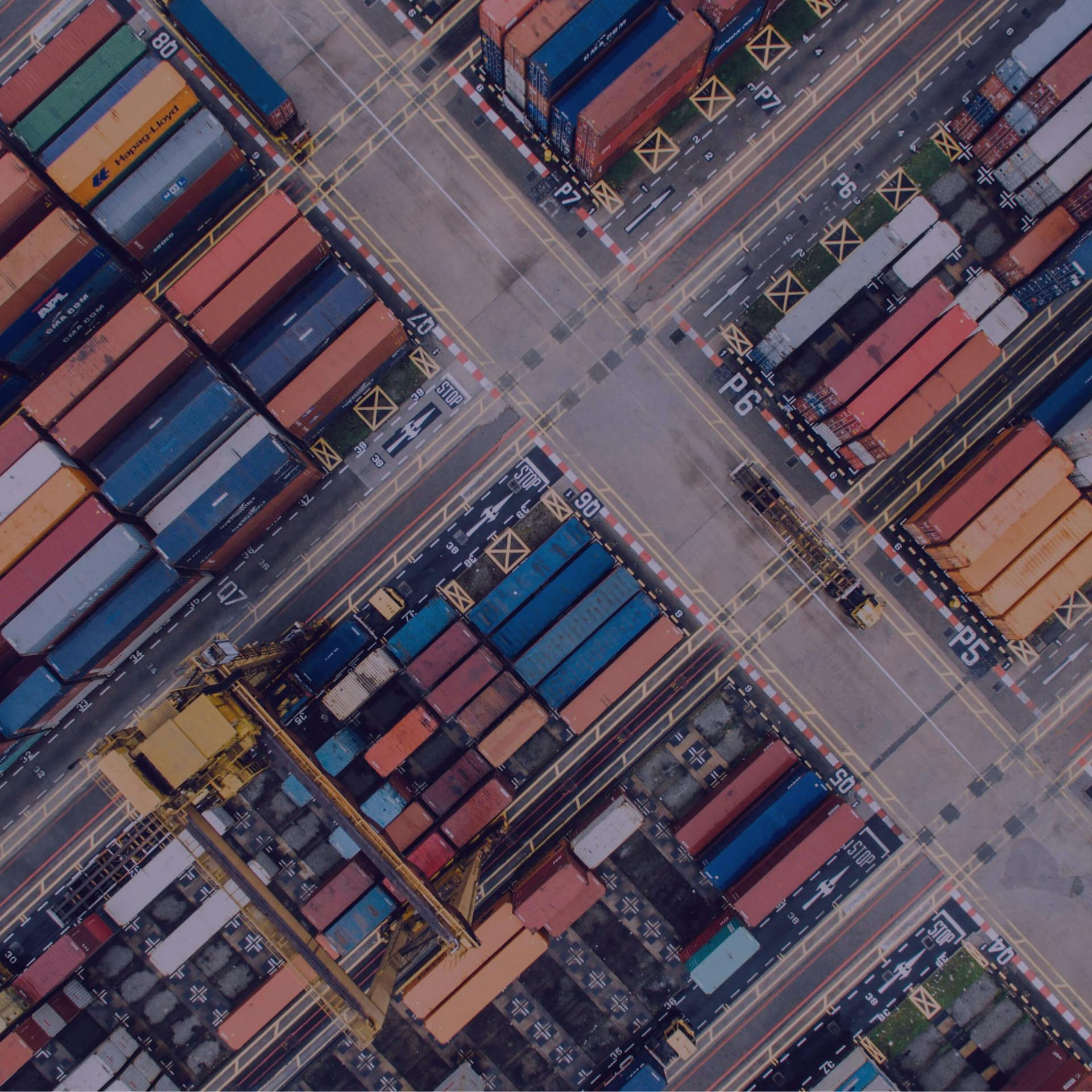 An aerial shot of a shipping dock with shipping containers.