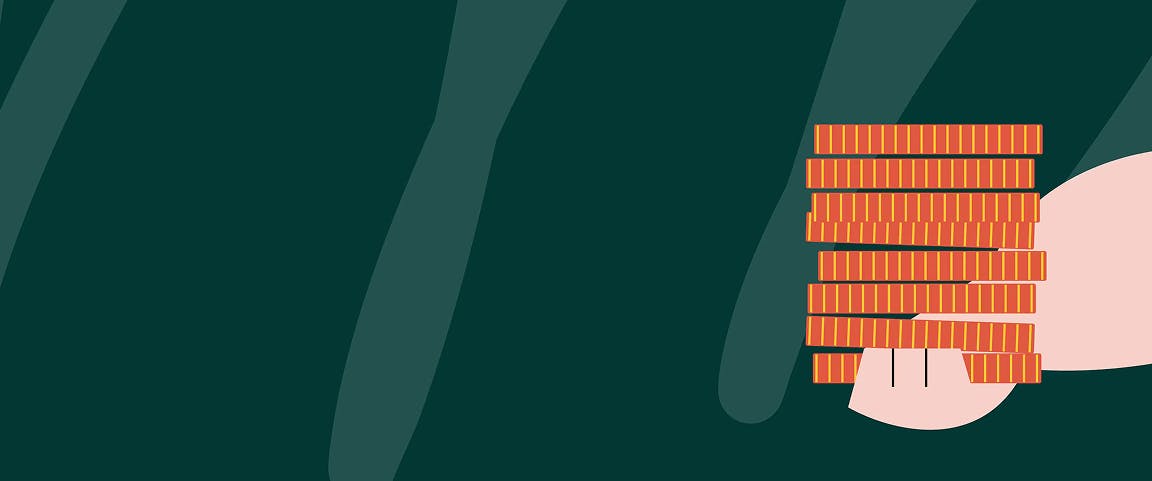 Hand holding up a pile of coins