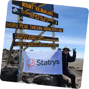 Photo of Bertrand at the top of Mount Kiliman Jaro