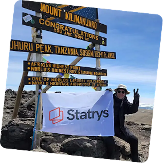 Photo of Bertrand at the top of Mount Kiliman Jaro