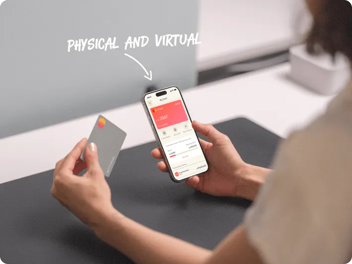 A lady holding up a Mastercard and a phone with the Statrys app
