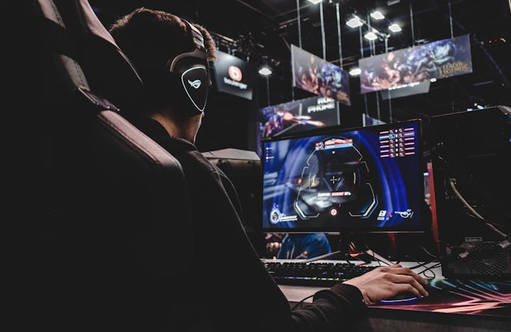 person sitting on gaming chair while playing video game
