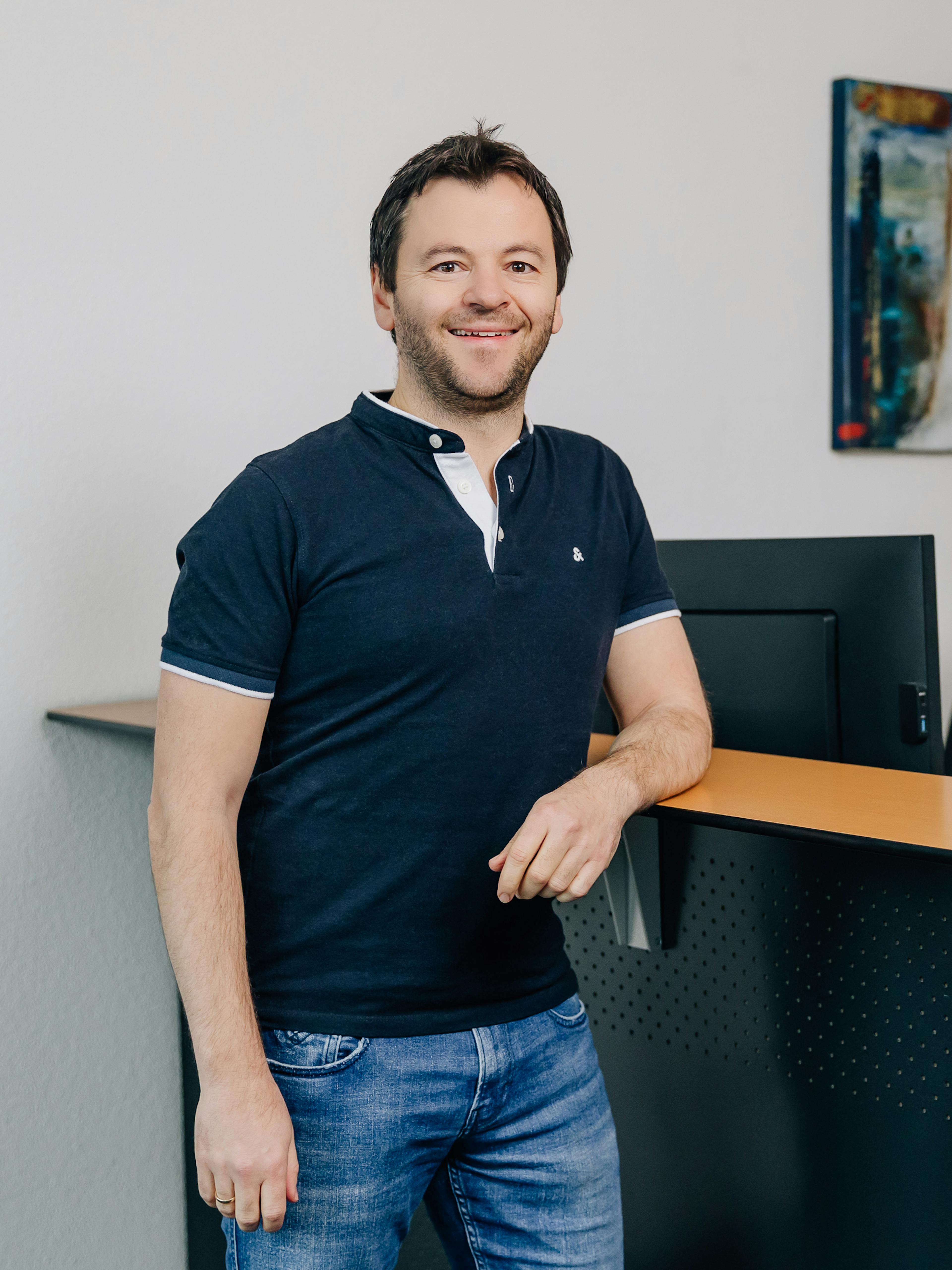 Bild von Pepi vor einem Schreibtisch
