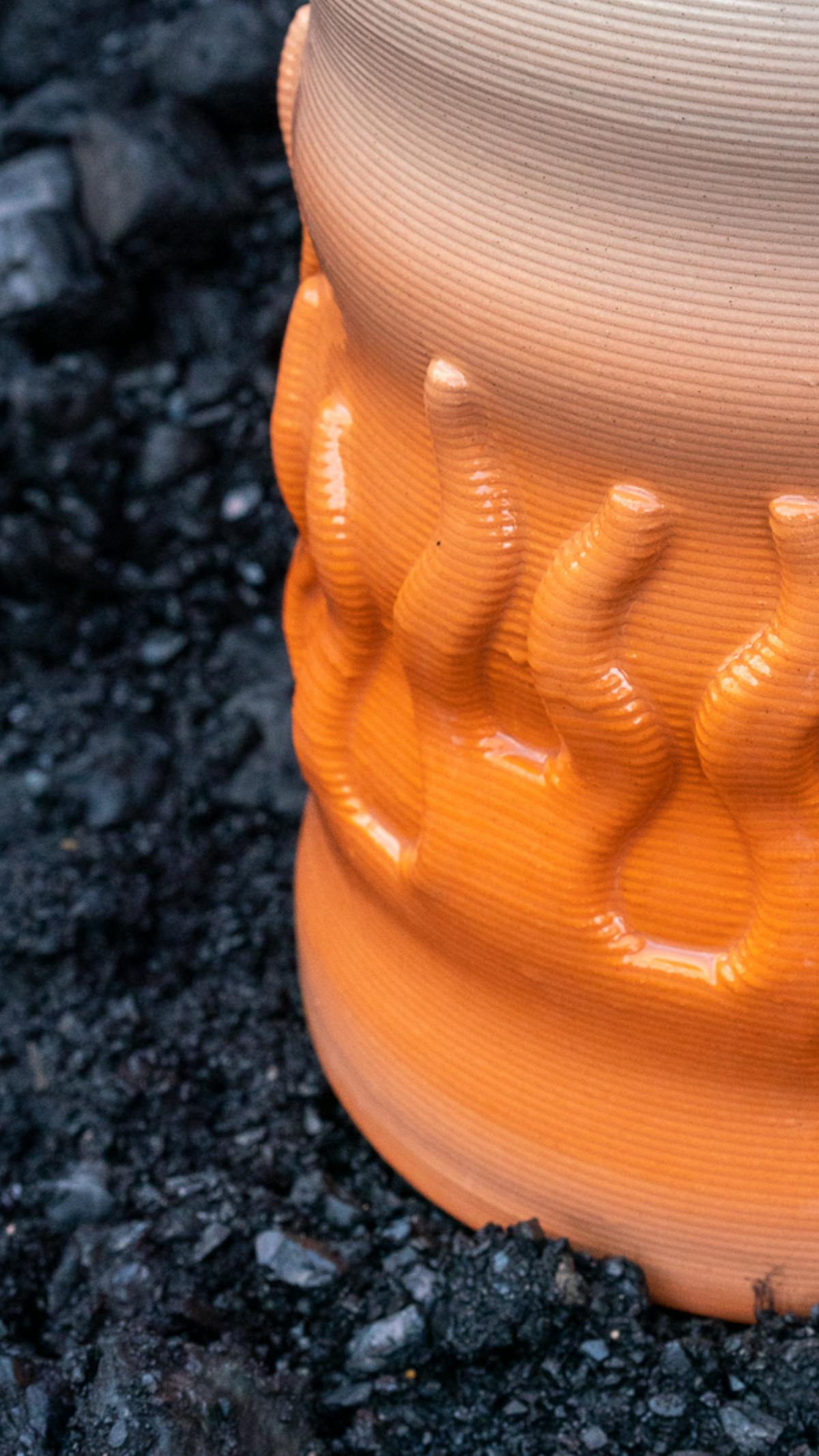 Detail view of 3d printed ceramic vase with flame relief