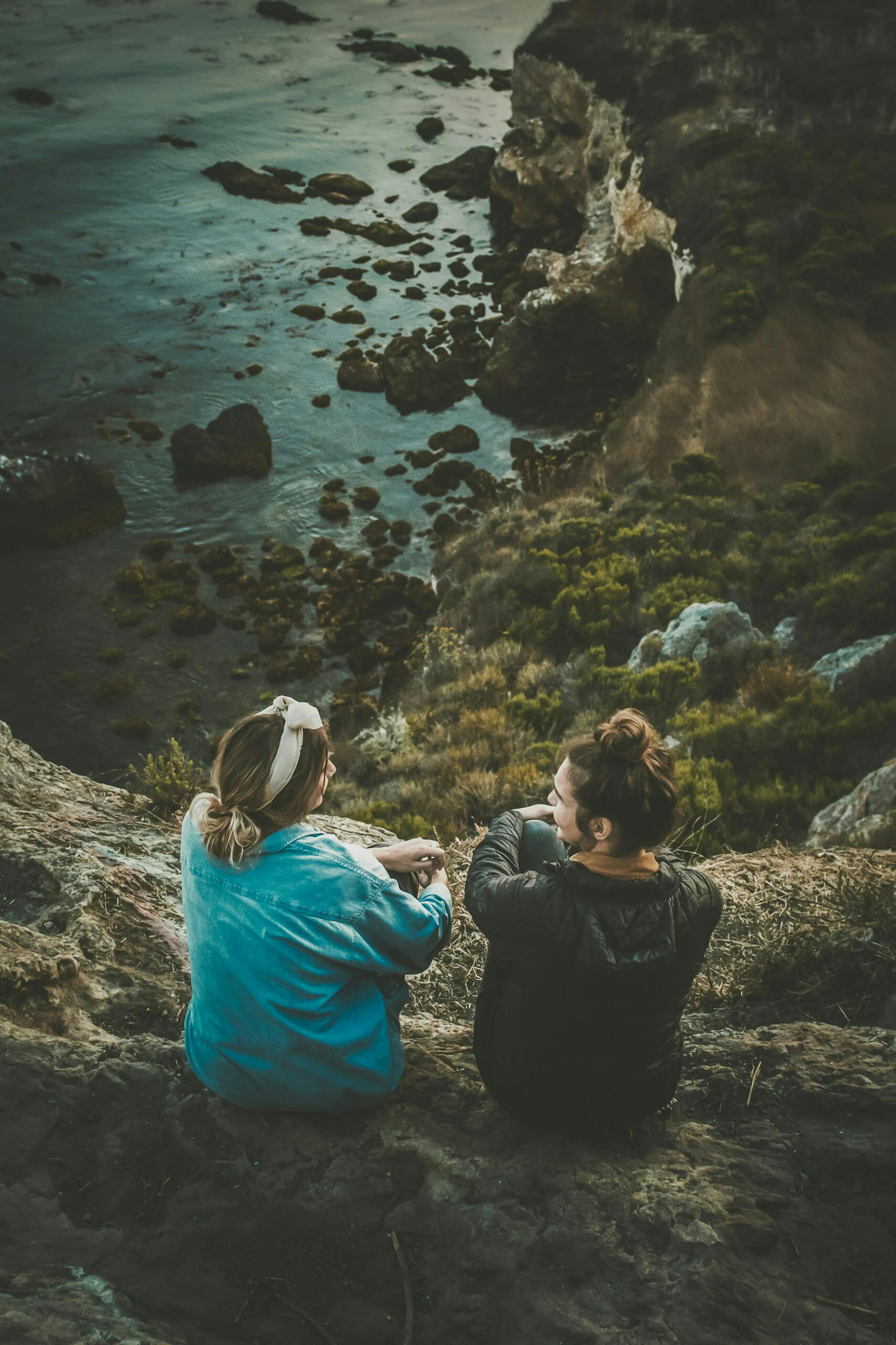 Couple overlooking rocks and sea