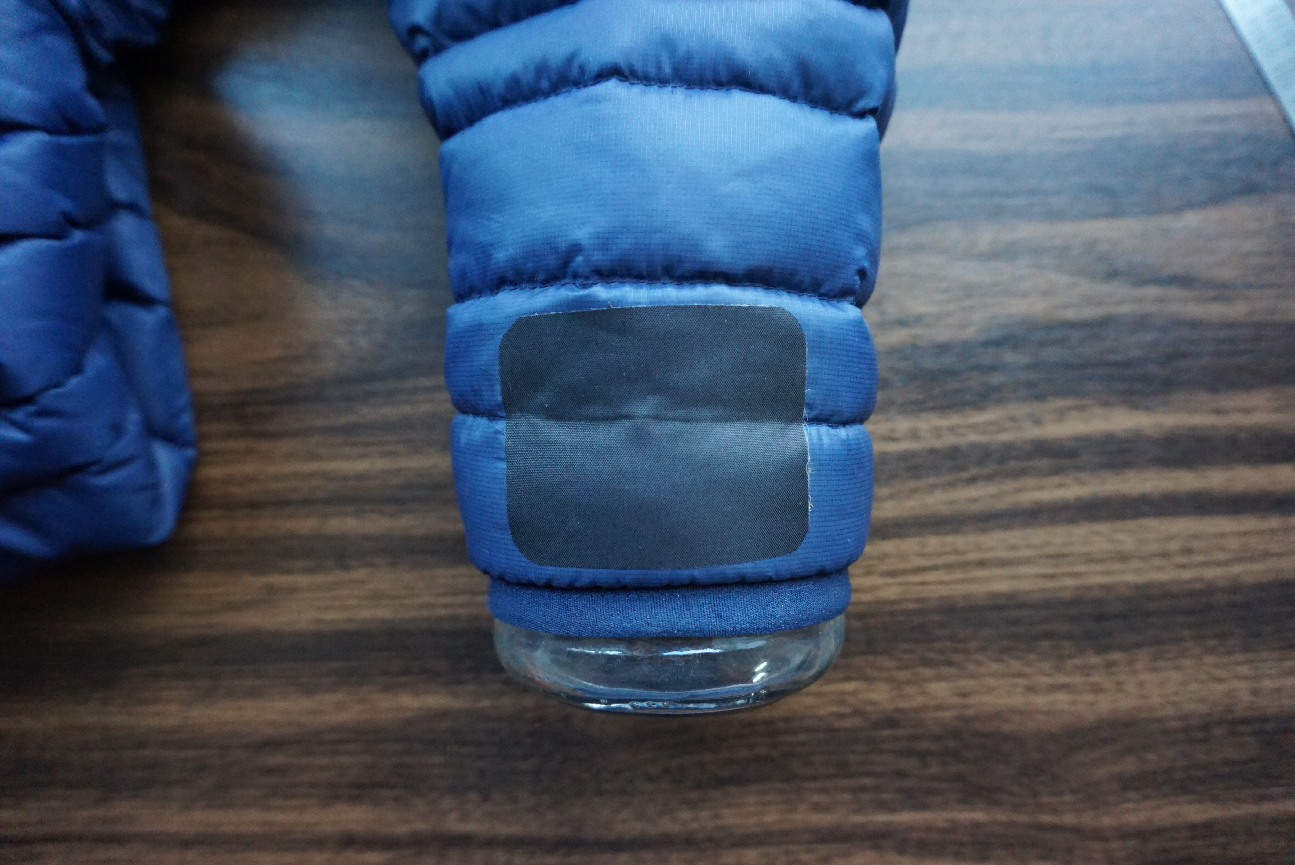 Image of a hand applying a patch to a tear in the gear