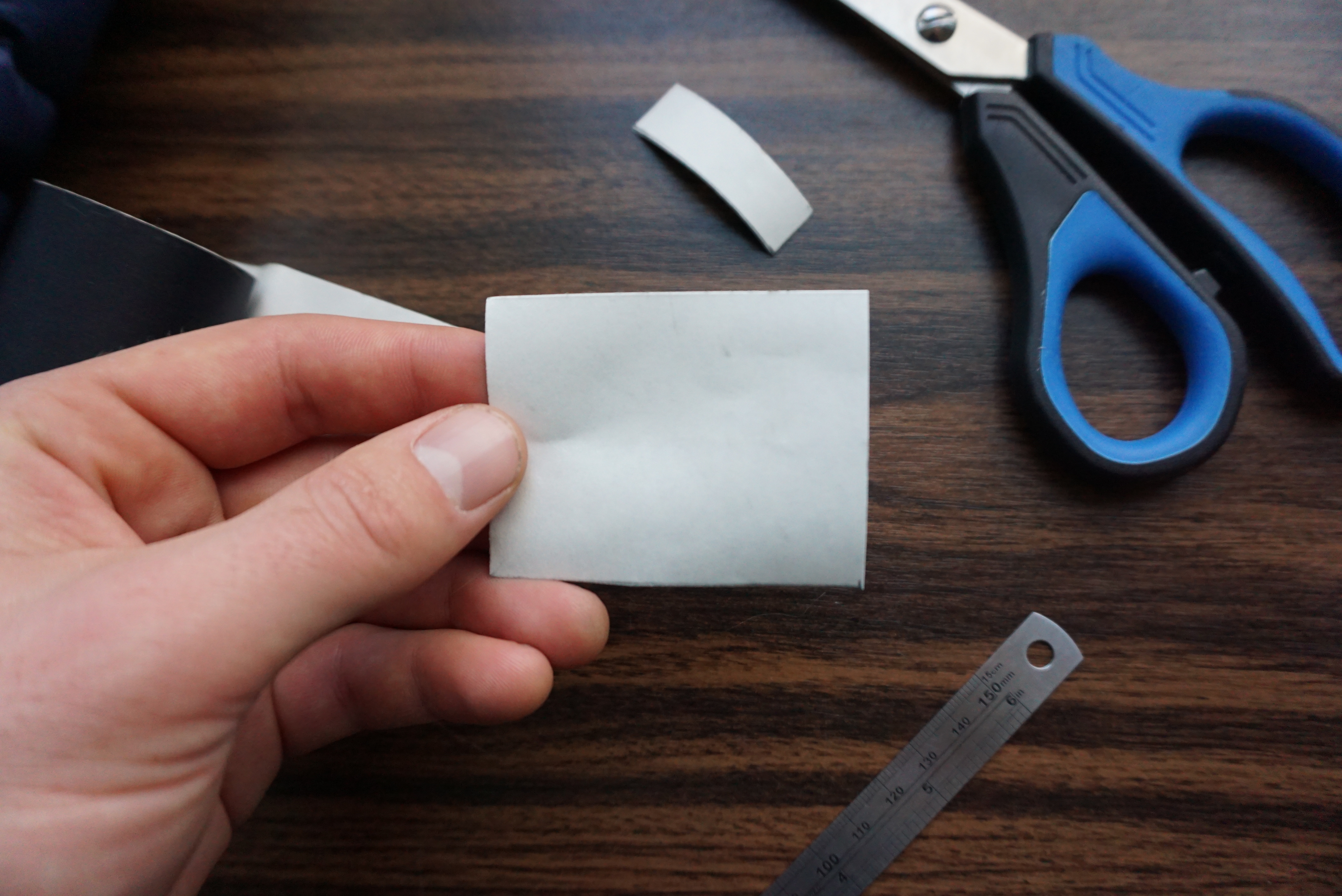 Image depicting scissors cutting a patch to size