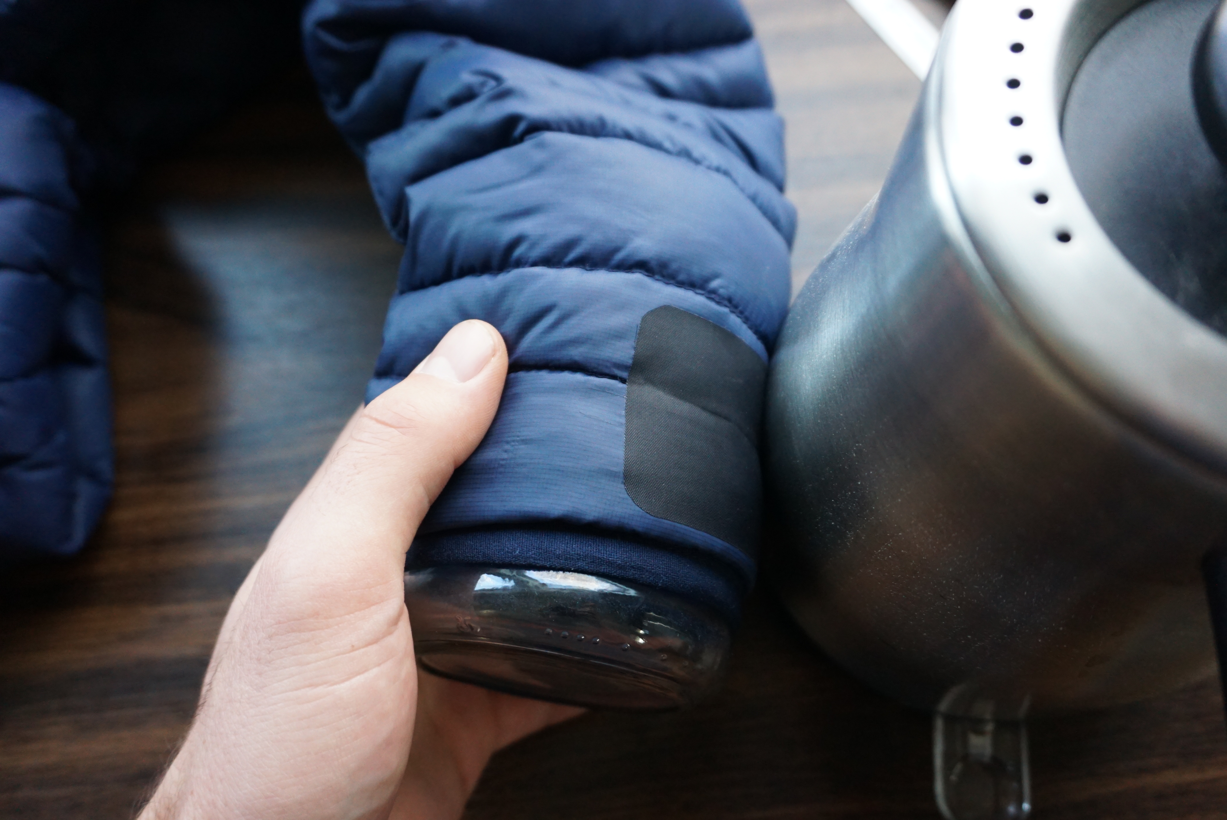 Image showing a patch being rubbed against the outside of a mildly hot kettle to increase adhesion
