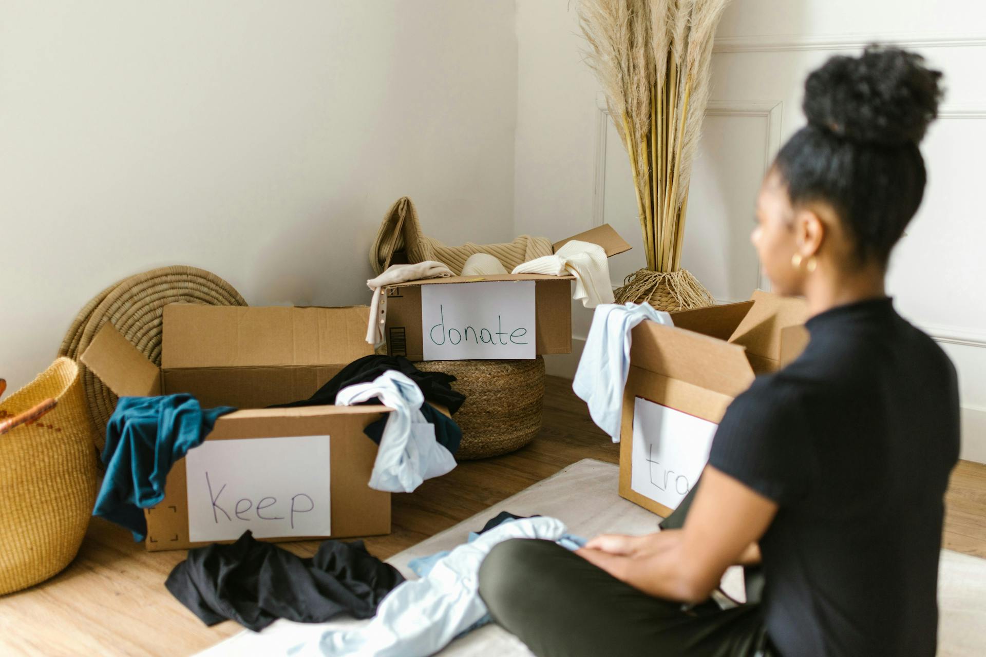 woman organizing clothes into boxes