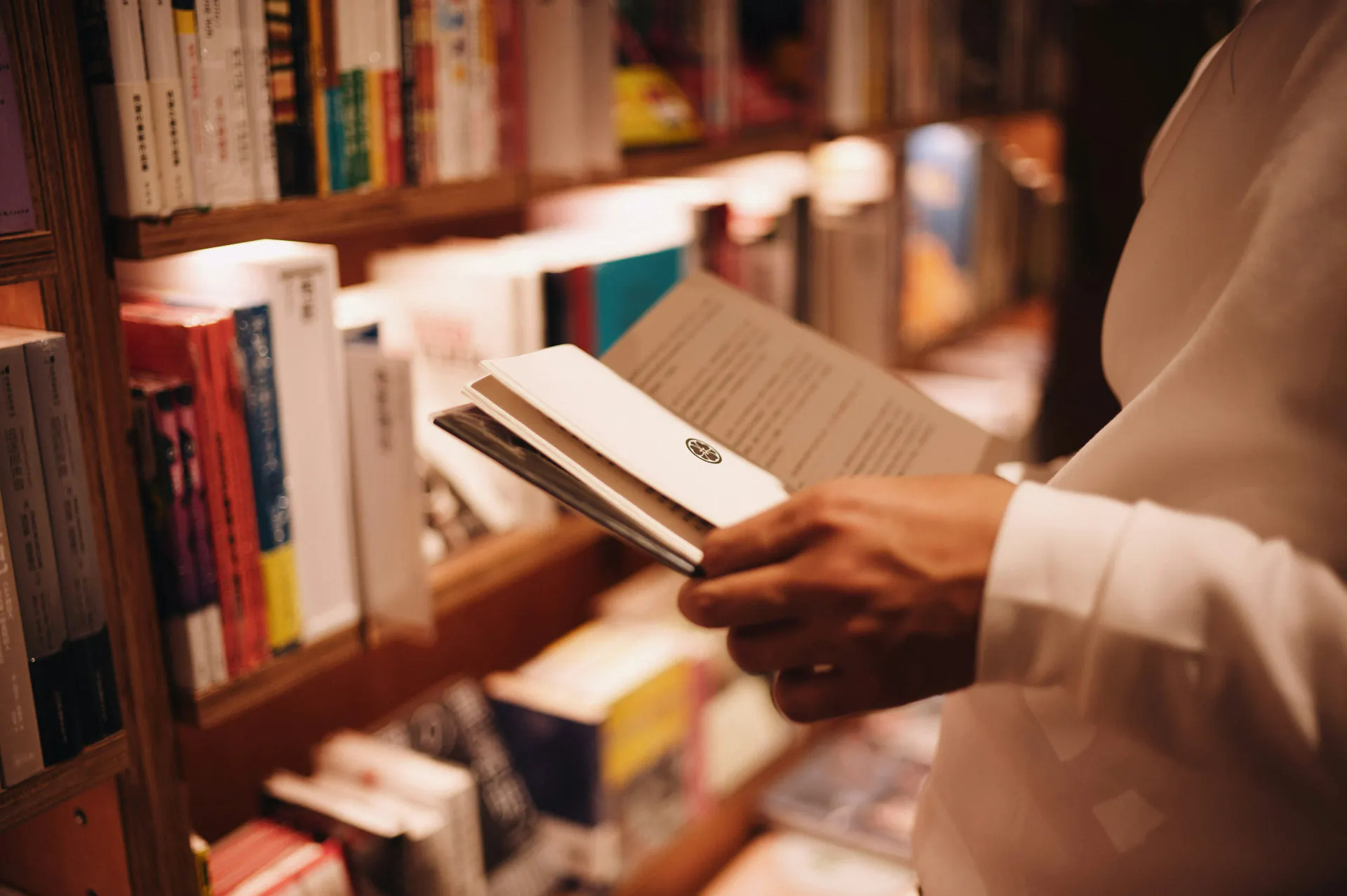 A close-up of someone browsing books at the Madison Public Library.