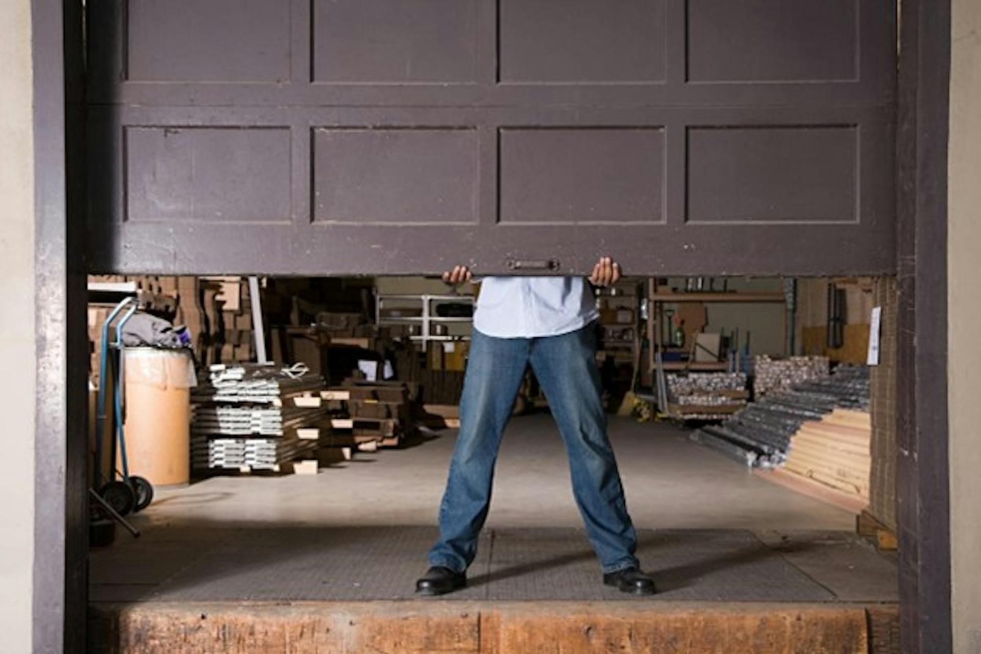 Man opening the door to their garage.