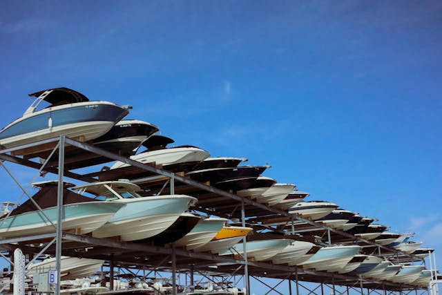 a row of boats sitting under a blue sky