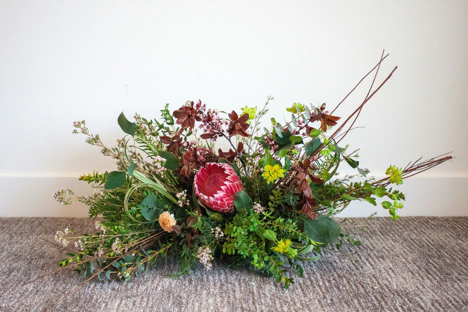 A newly crafted centerpiece on a carpeted floor.