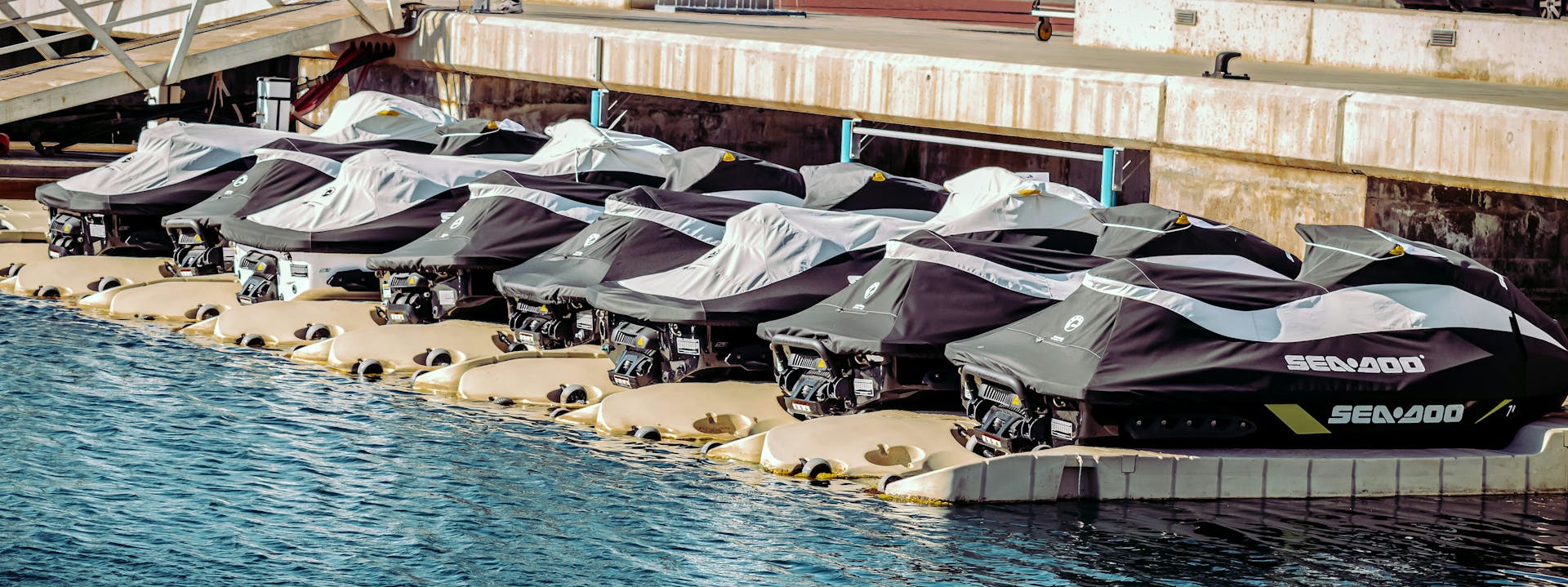 A row of jet skis protected by outdoor covers