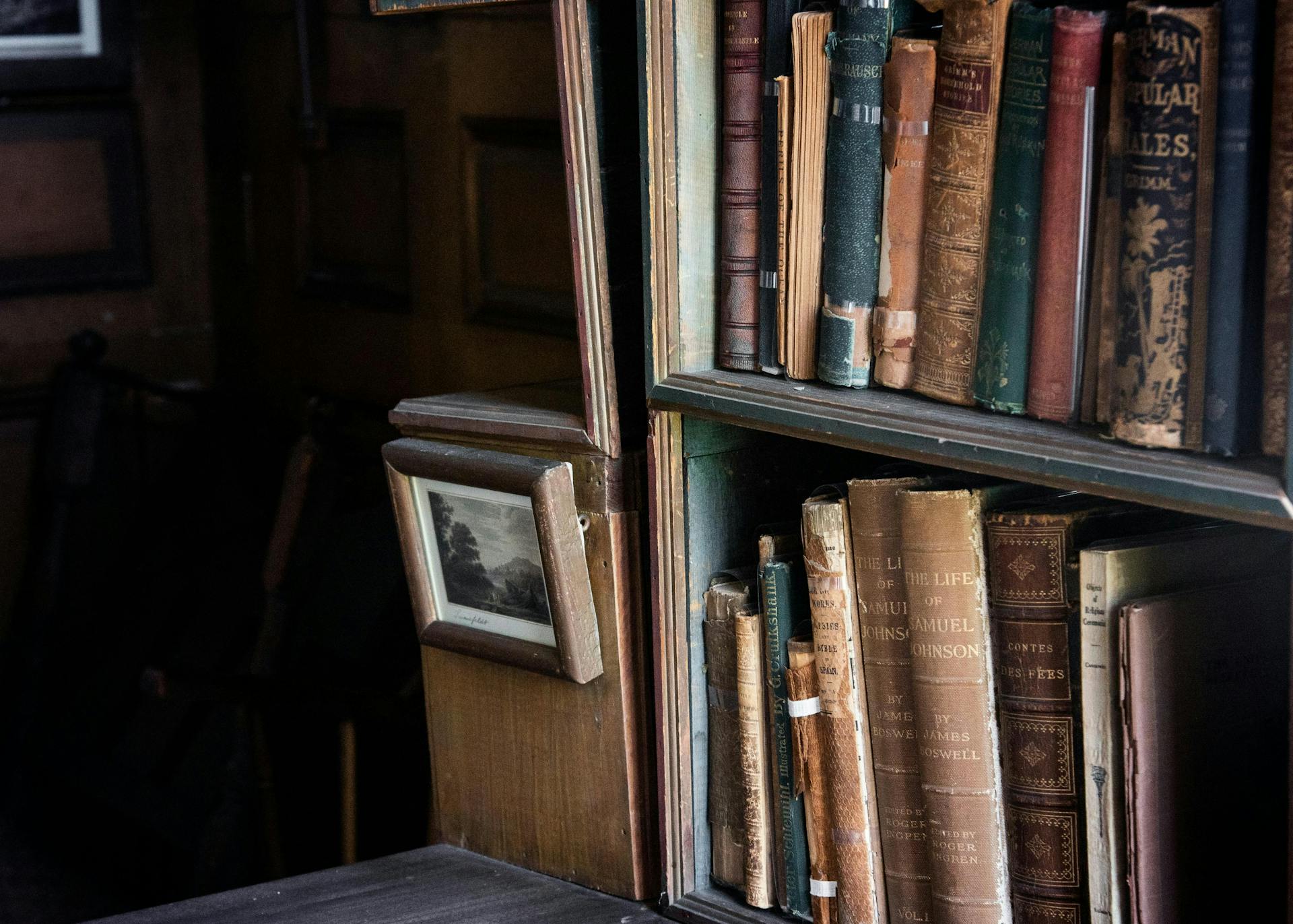 Antique books on a wooden bookcase