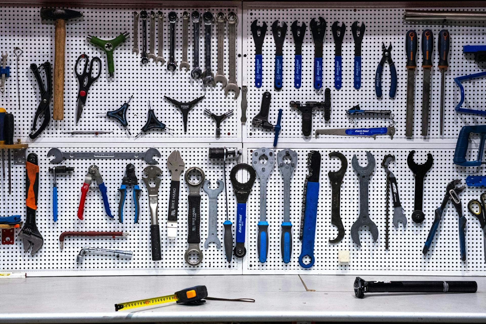 a pegboard displaying a set of organized tools 