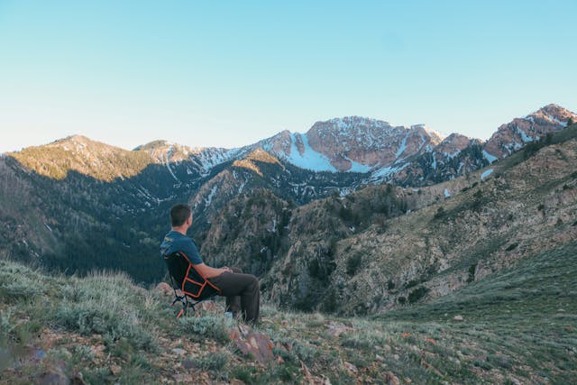 a man sitting on a chair at deseret peak in Utah 