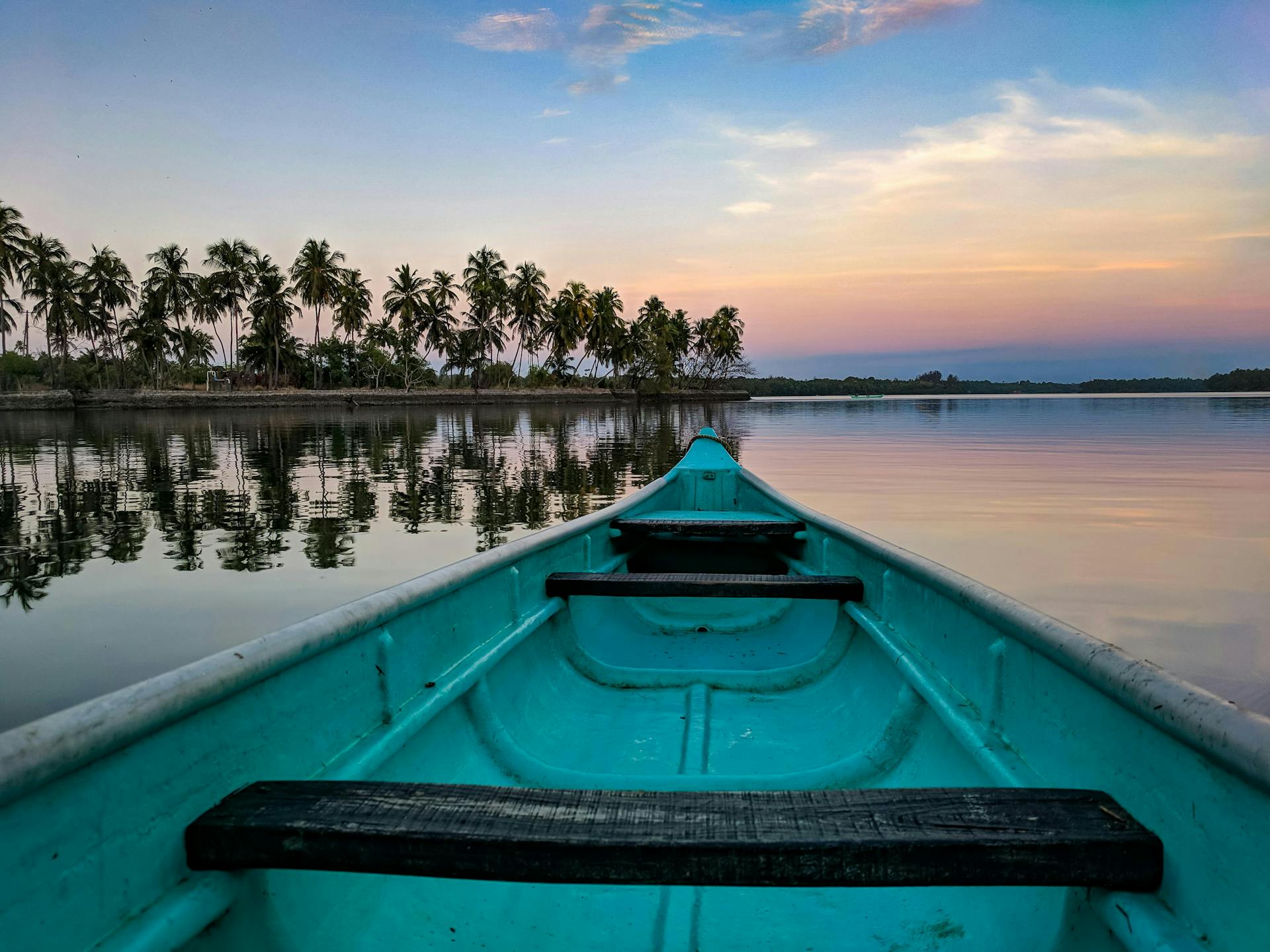 A blue canoe on the lake.