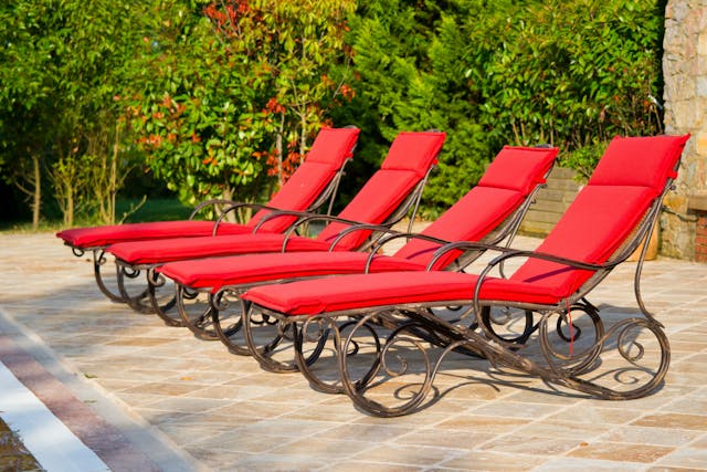 poolside lounge chairs with red cushions